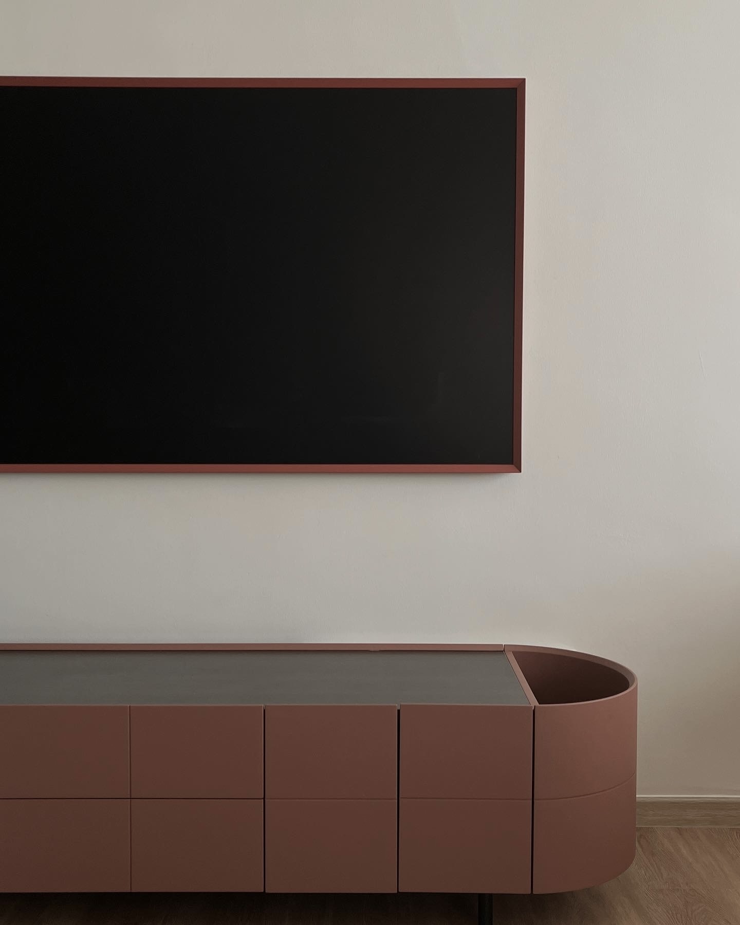 Living Space: our favourite spot at home - Modern minimalist wall-mounted TV, sleek brown and gray cabinet, abstract art