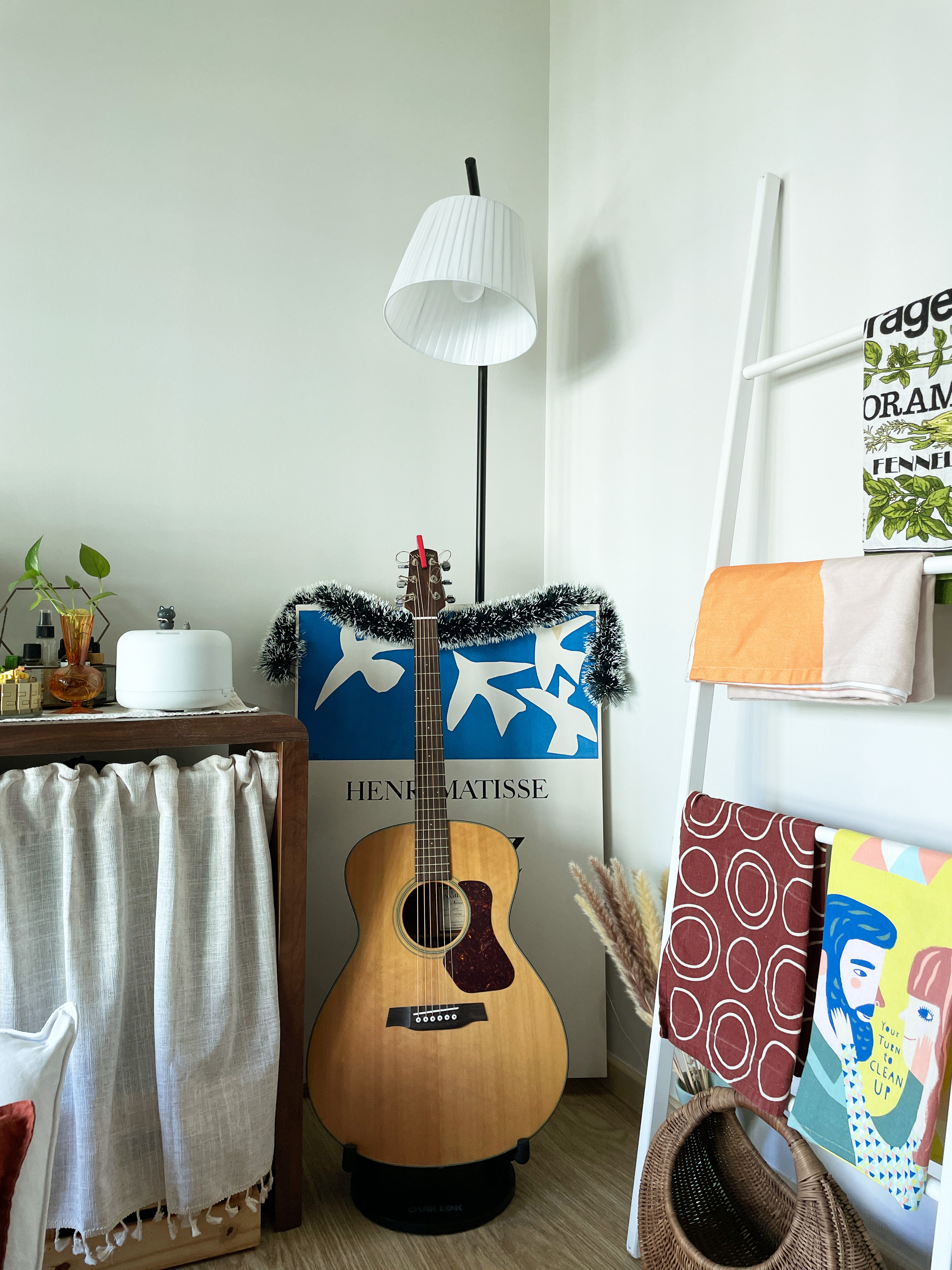 Psst... This is not your Typical Living Room 😳  - Guitar, hanging, white lamp, white curtains, colorful towels, wooden