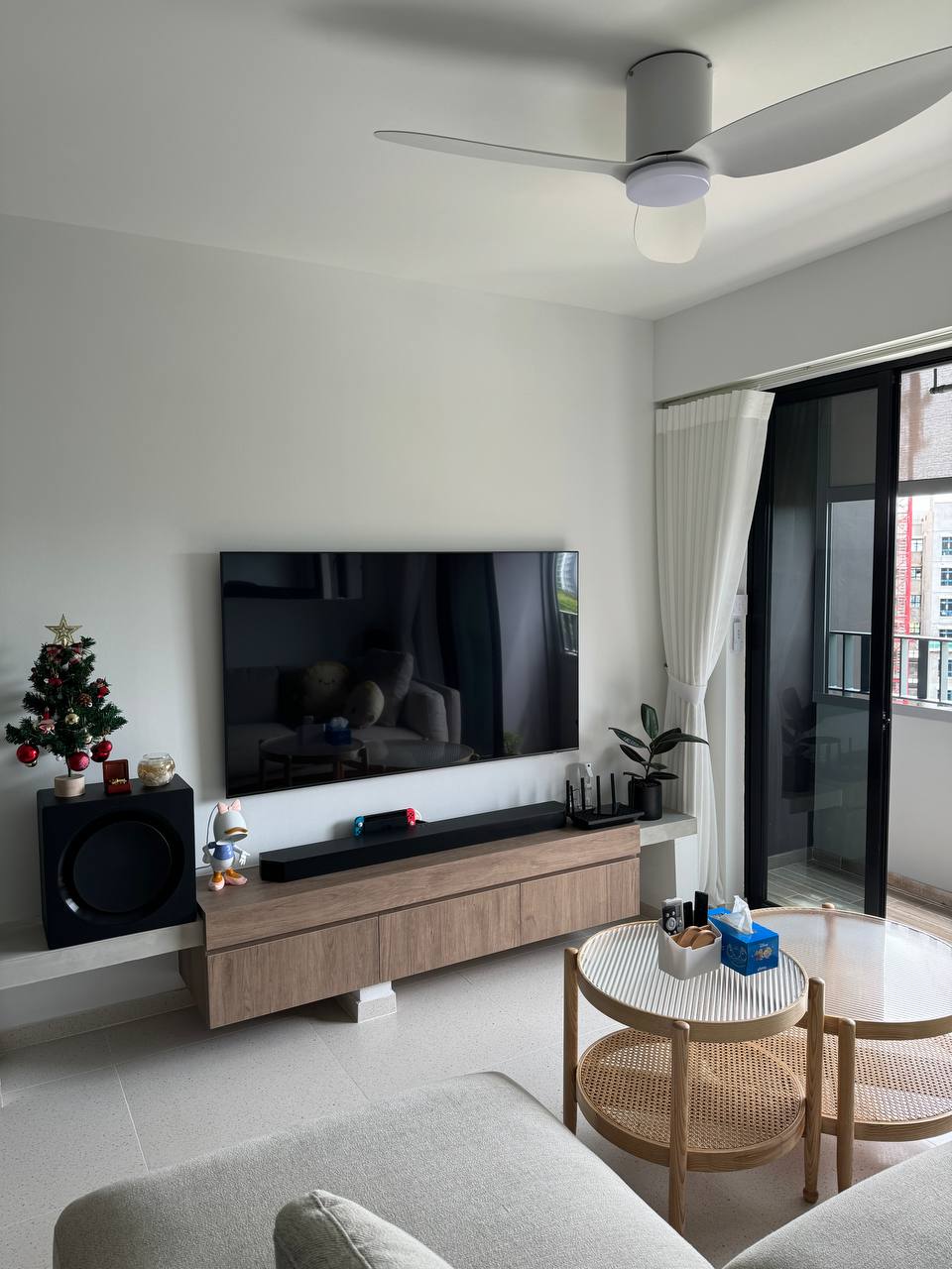 The Perfect Corner to be a Couch Potato - Modern living room, minimalist decor, sleek ceiling fan, large flat-screen TV, cozy