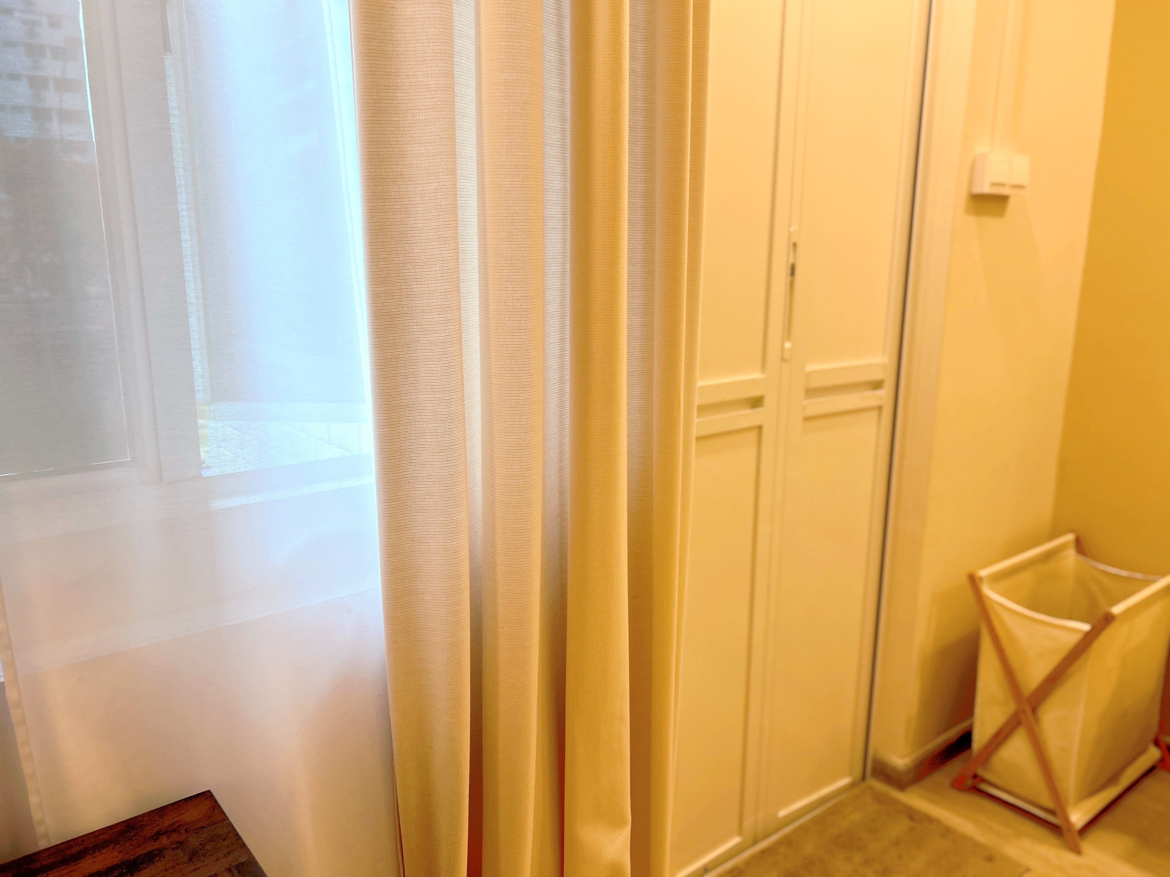 Welcome to our tranquil bedroom sanctuary, where relaxation awaits! - Golden curtains, sheer white window, light yellow