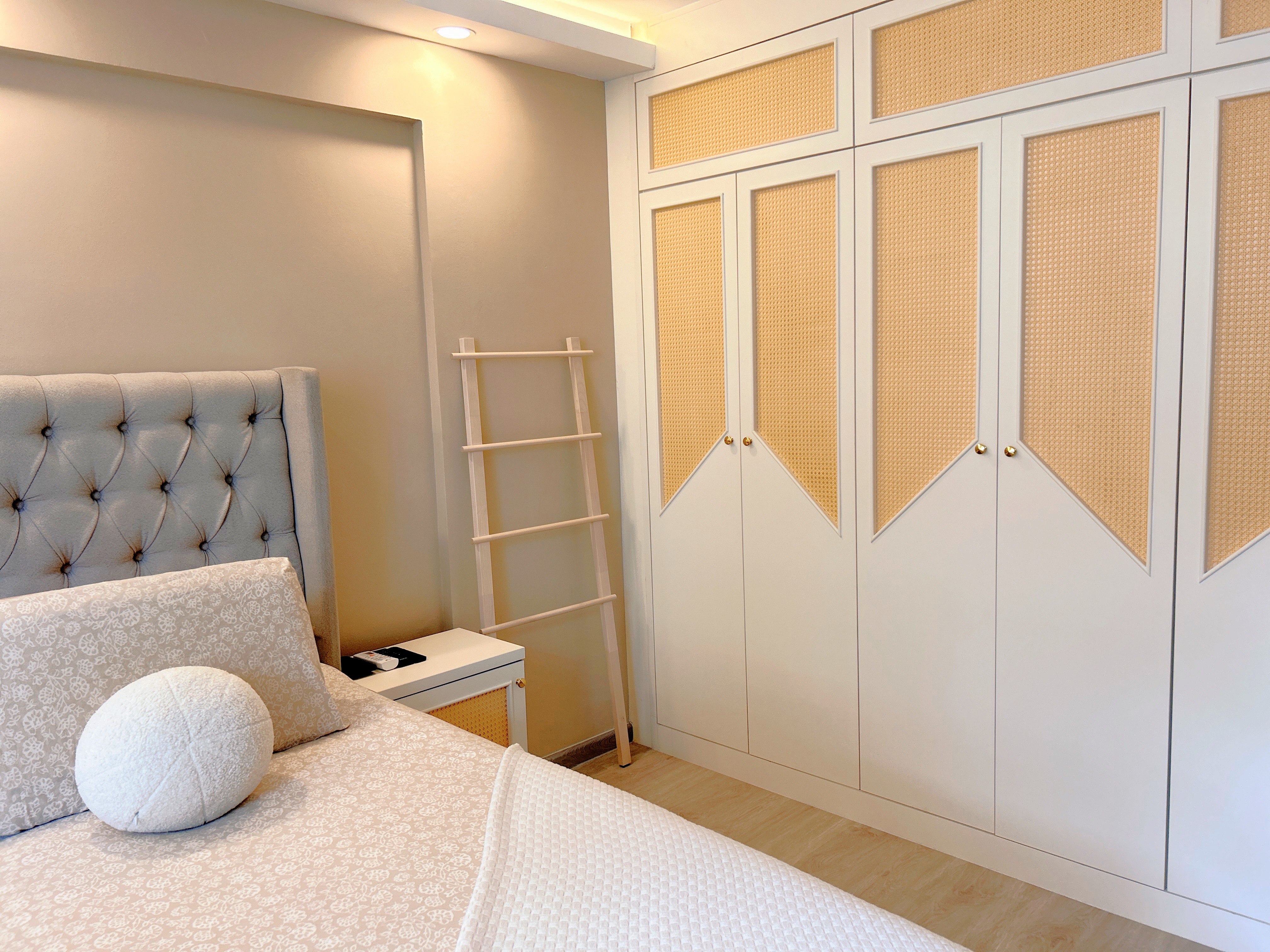 Welcome to our tranquil bedroom sanctuary, where relaxation awaits! - Cream tufted headboard, beige patterned pillows, wooden
