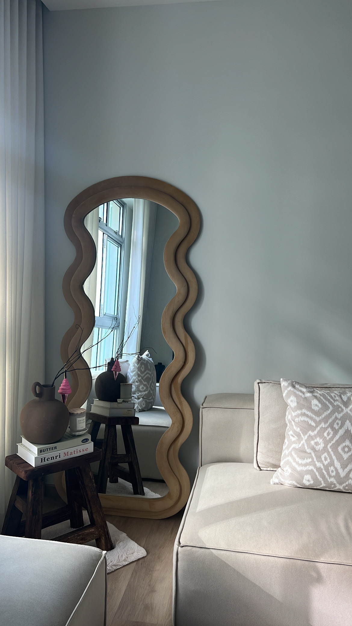 Living room from different angles! - Wrought iron mirror, wavy design, light blue walls, cozy room, beige sofa, patterned