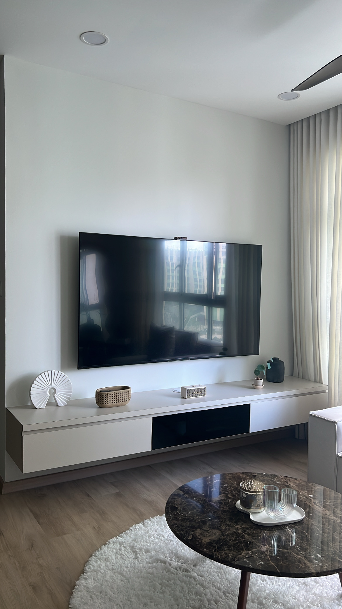 Living room from different angles! - Modern minimalist living room, sleek entertainment center, large flat-screen TV, white