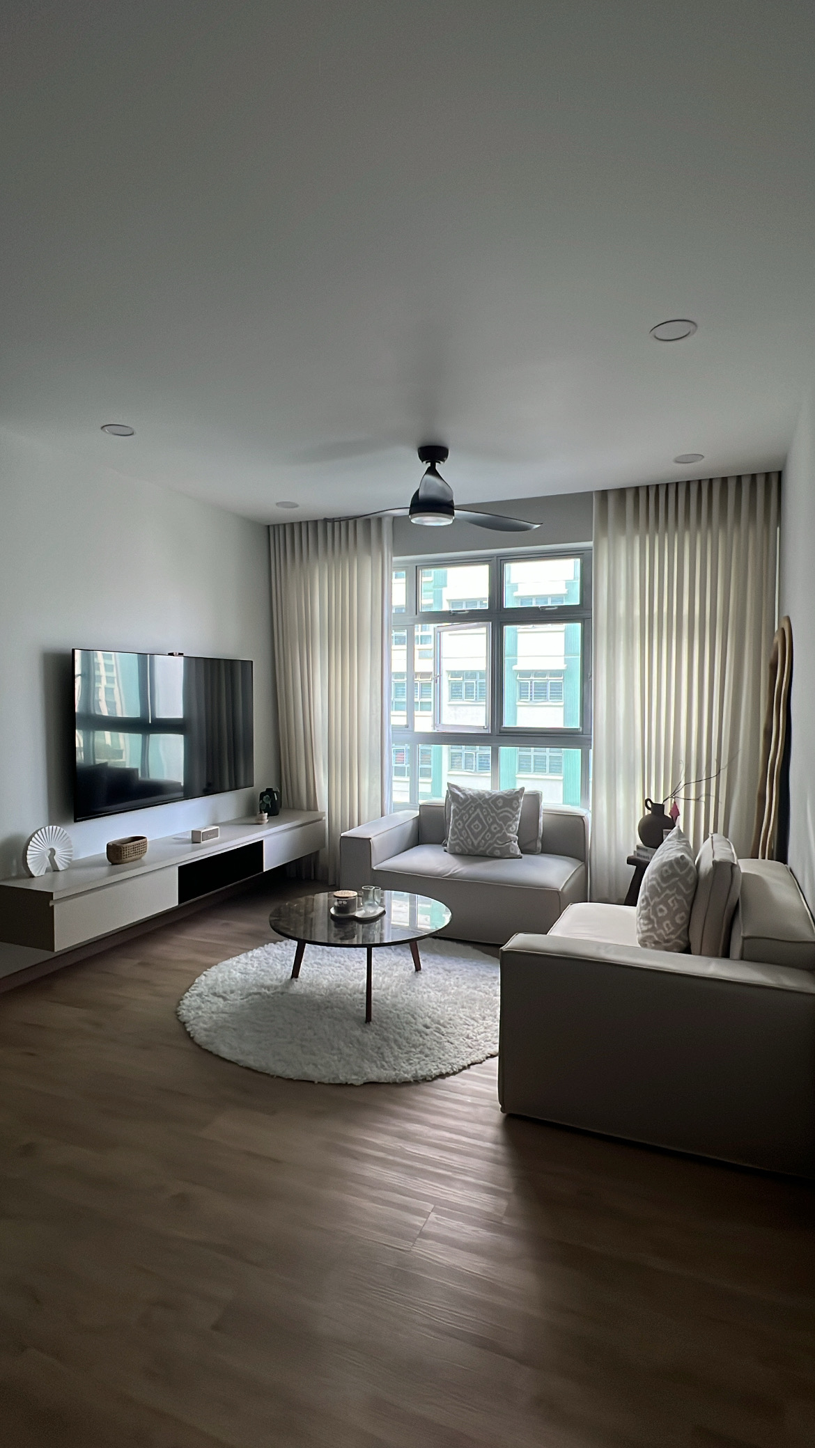 Living room from different angles! - Modern living room with sleek design, large flat-screen TV, minimalist decor, neutral