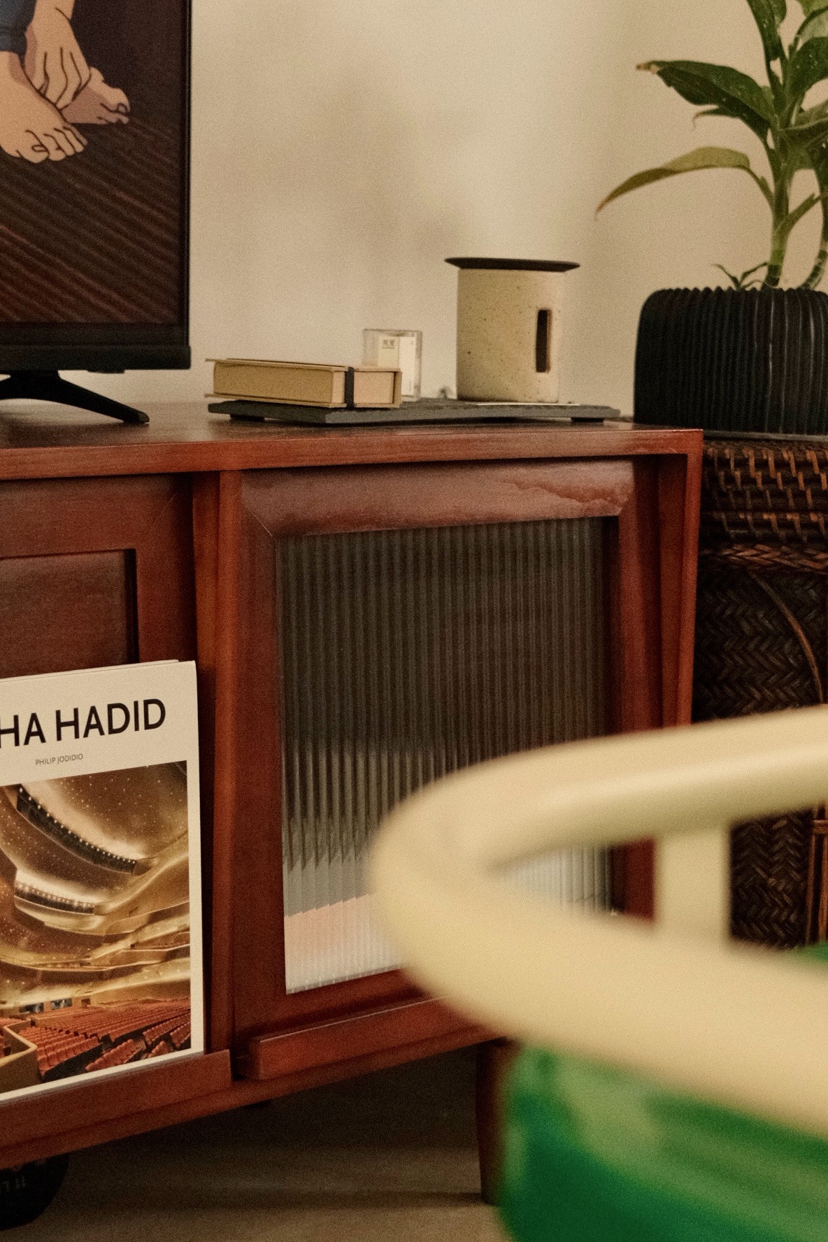 Open living room concept for a heritage style artsy home - Wooden cabinet with a framed artwork of hands on a table