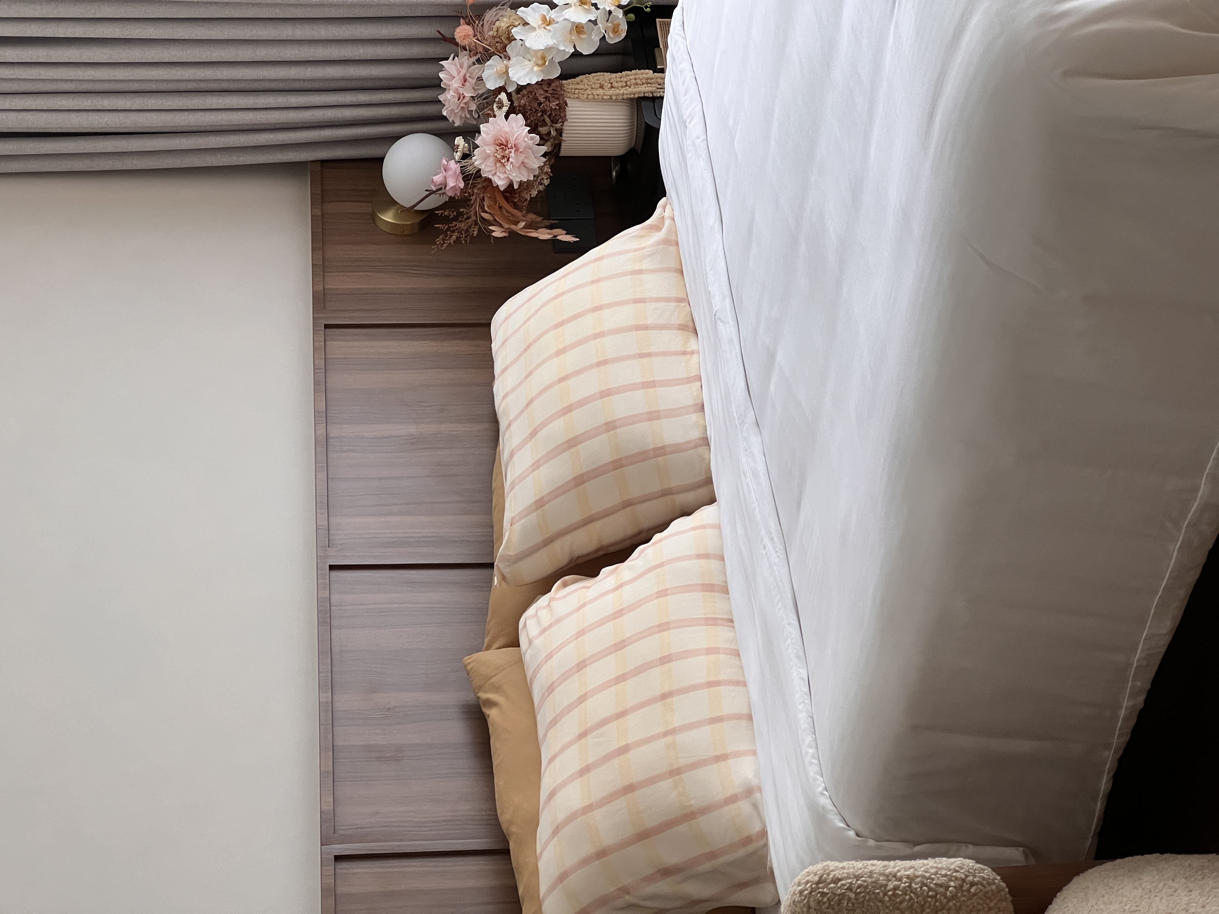 The beauty of greens and flowers.  - Soft, neutral-toned bedding, plaid pillows, beige and white checkered, wooden