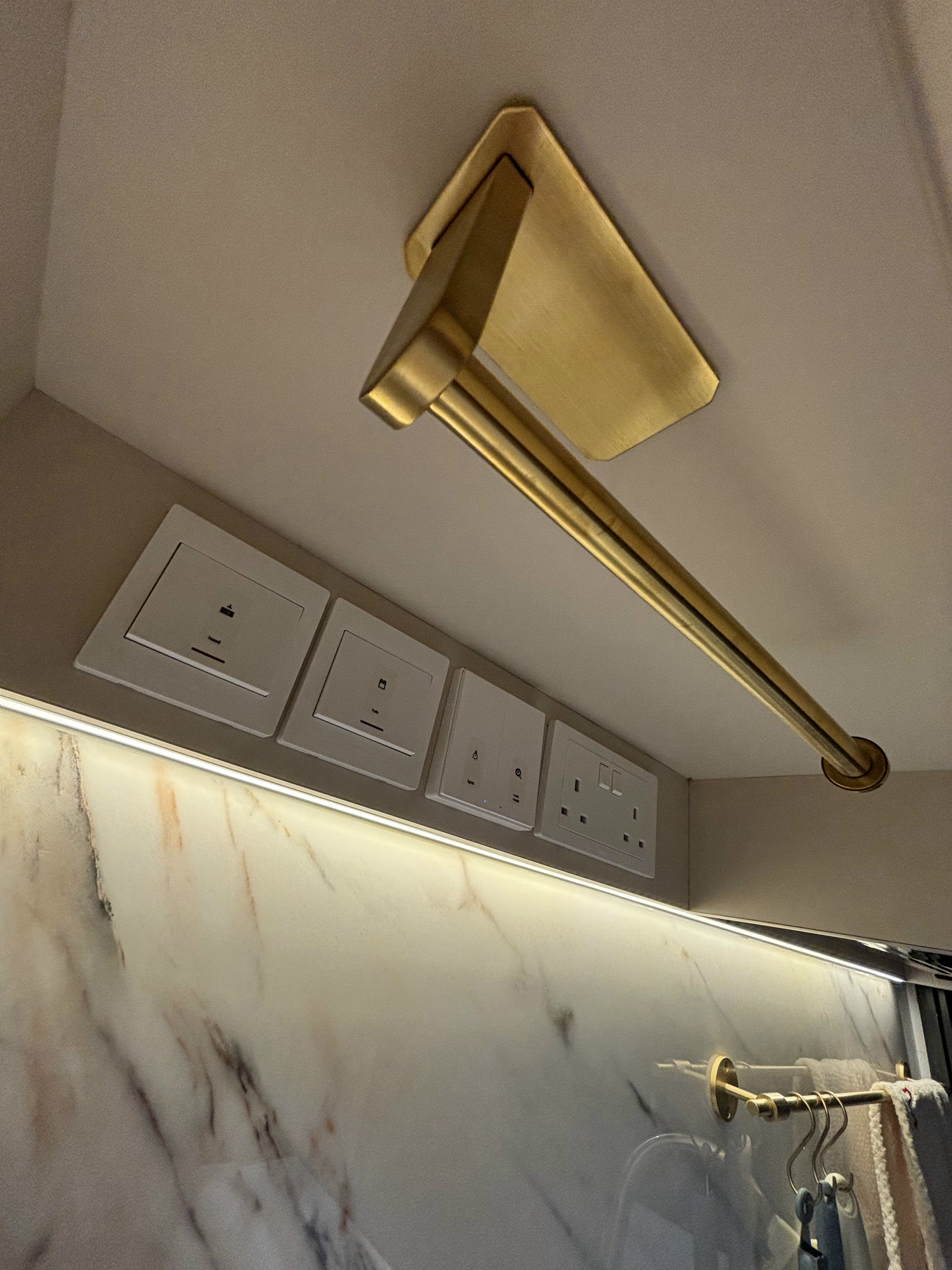 Our Favourite Features in the Kitchen - Gold ceiling light fixture, marble backsplash, modern electrical outlets, sleek