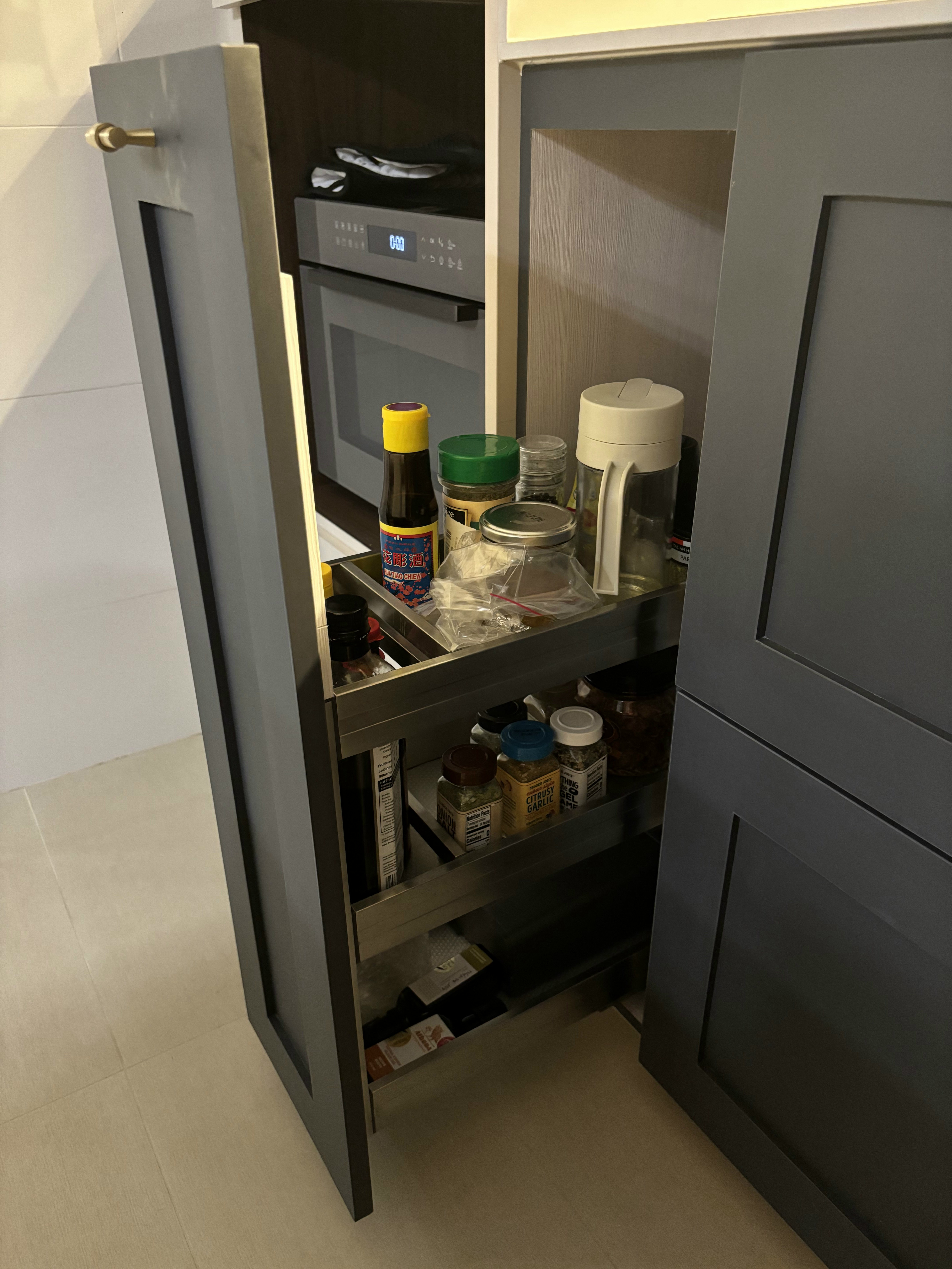 Our Favourite Features in the Kitchen - Shelf stocked with various condiments and kitchen items, kitchen cabinet door open