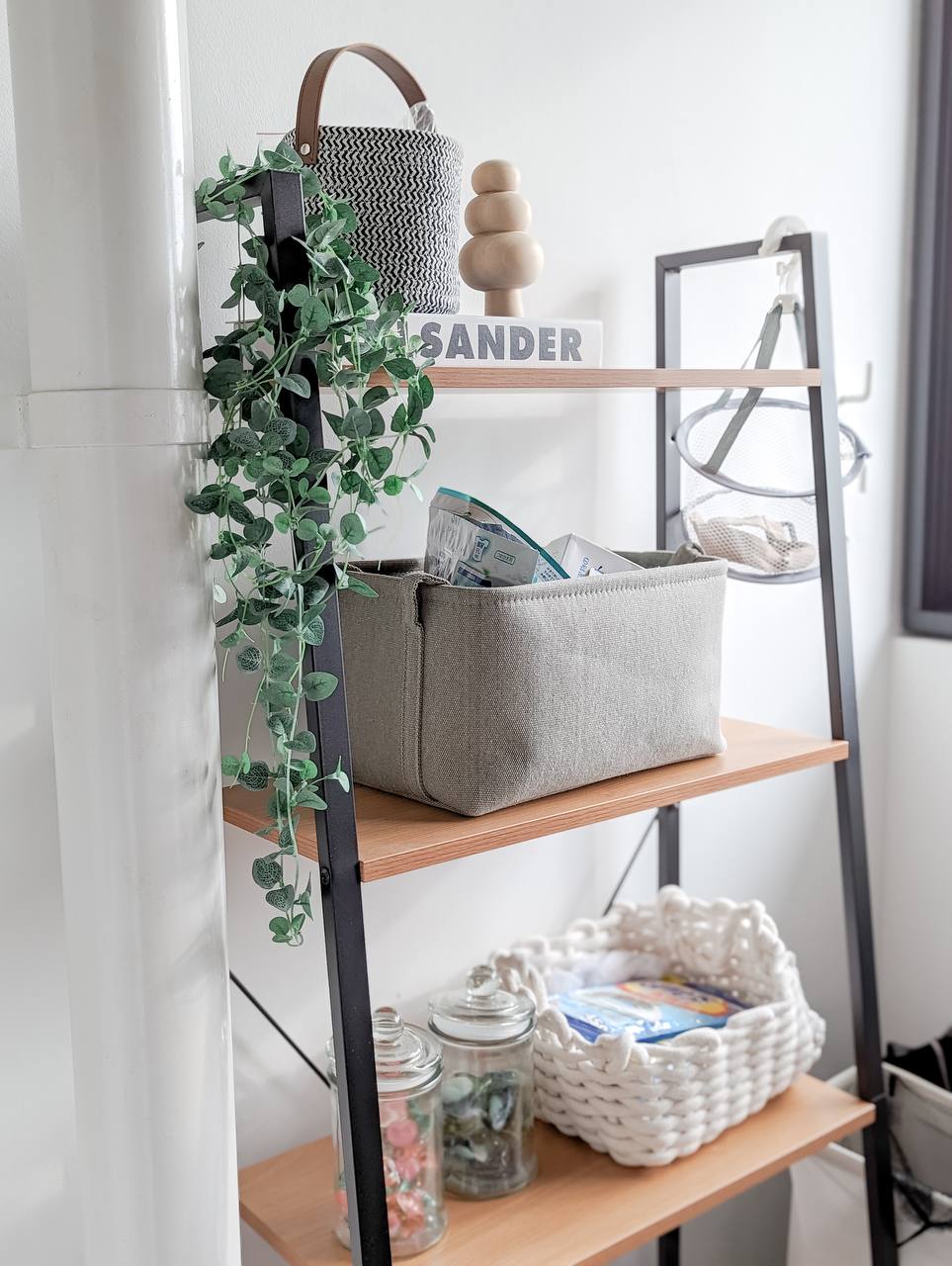Our Minimal & Simple Area Service Yard - vibrant green ivy, woven basket, minimalist decor, wooden shelf, black metal stand
