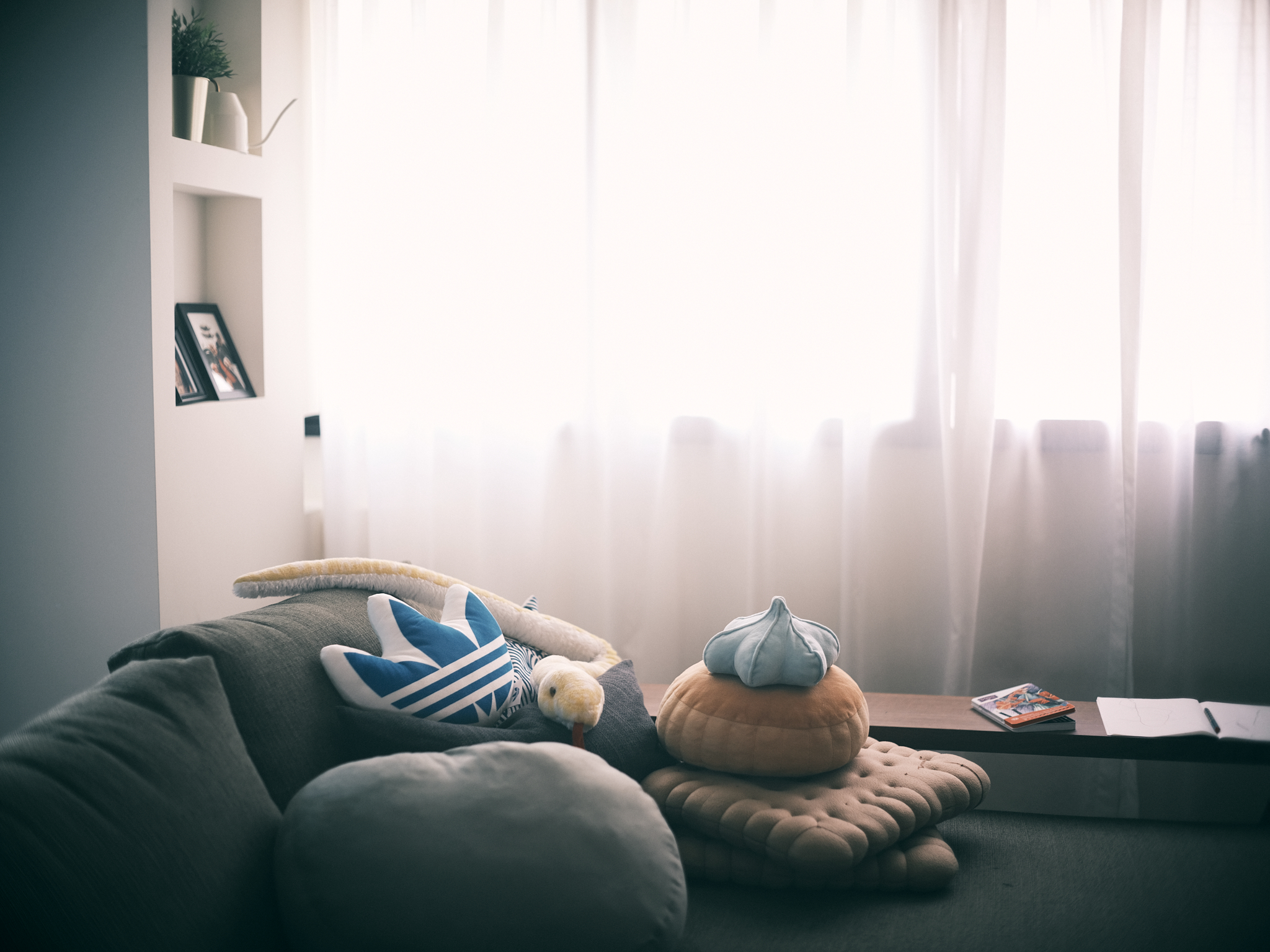 A relaxing mid-century family lounge area - Soft, cozy living room, modern decor, comfortable seating, plush pillows