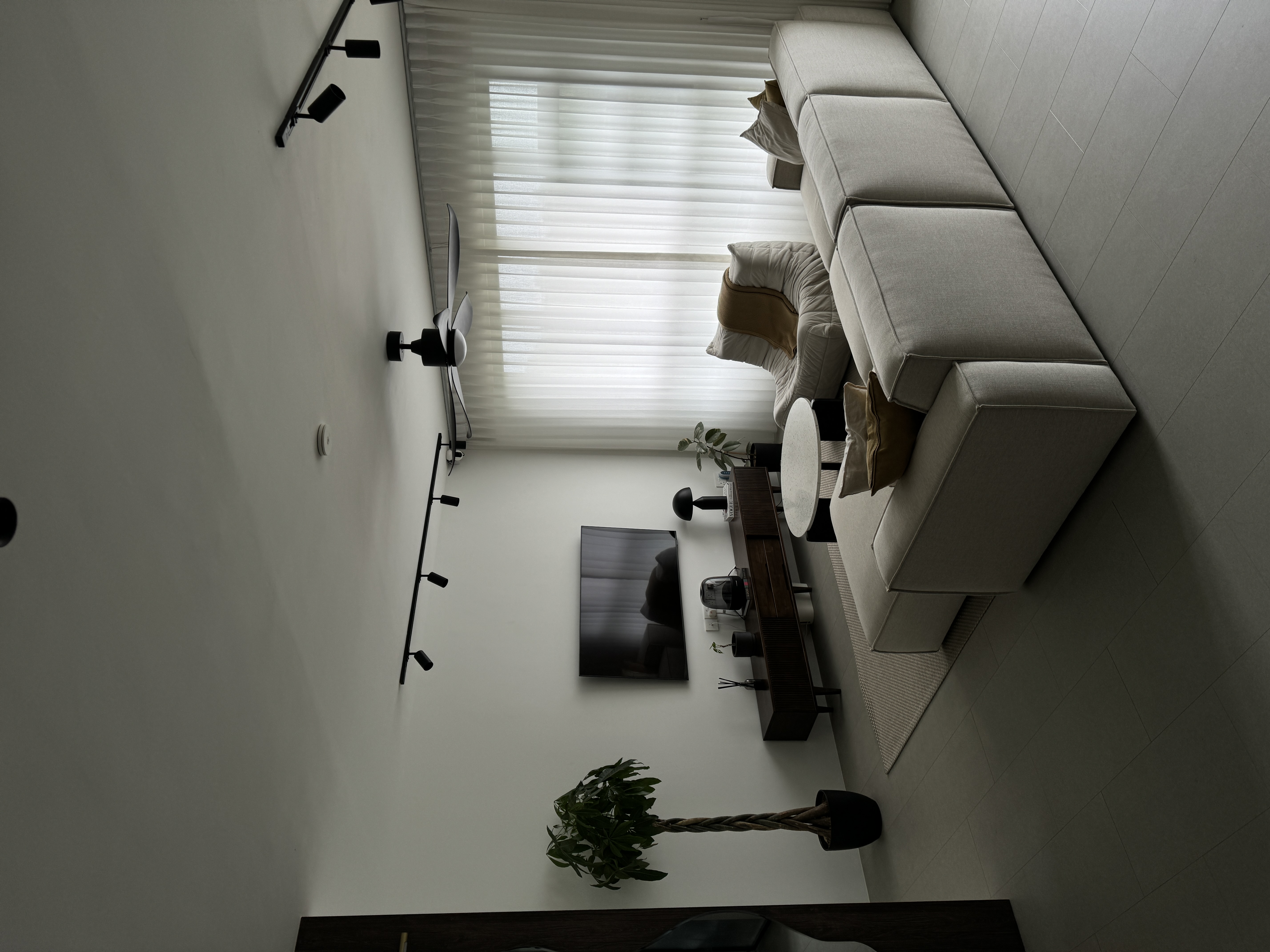 Neutral About Our Living Room - Modern minimalist living room, sleek black floor lamp, white wall, large window with blinds