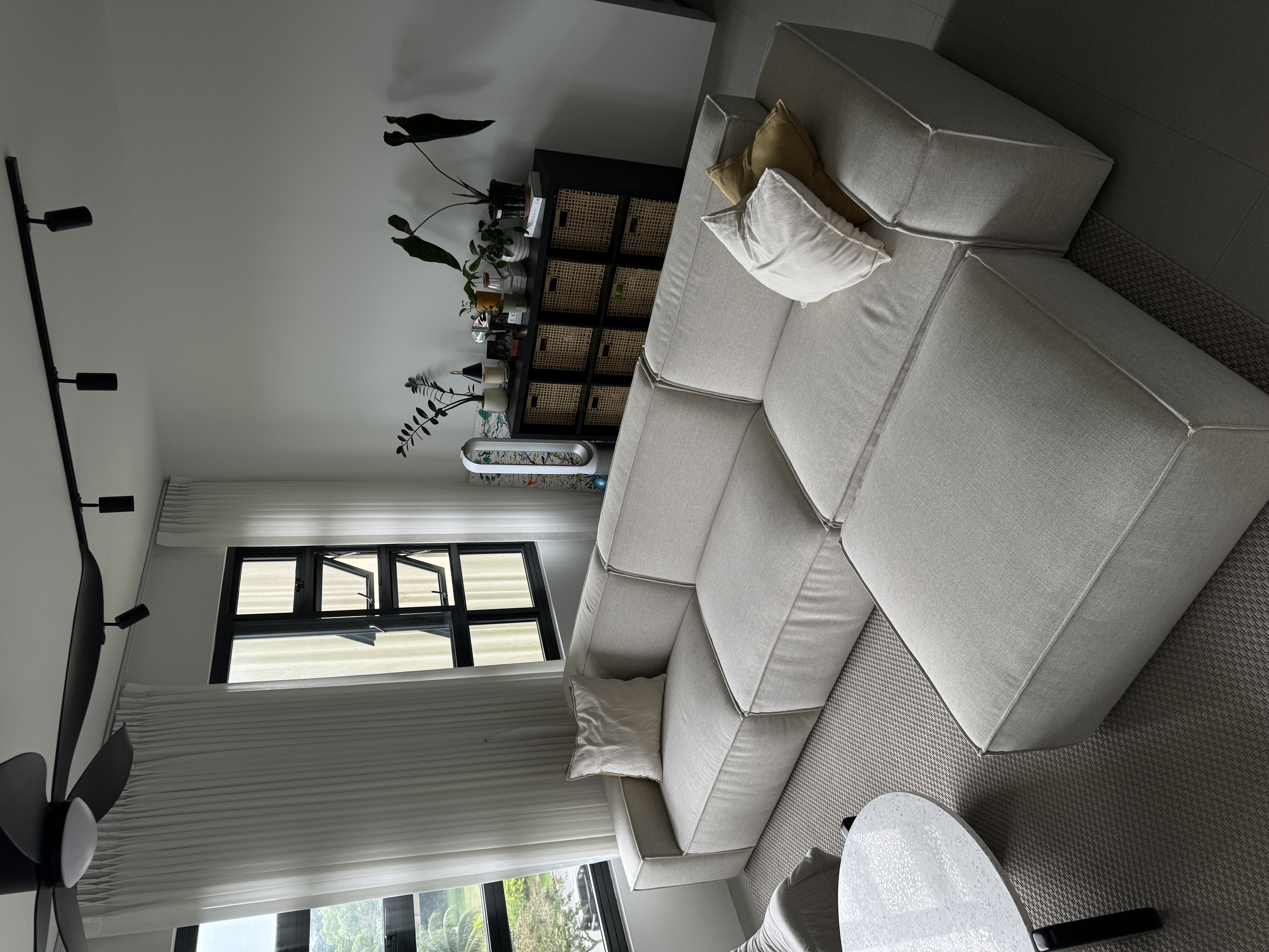 Neutral About Our Living Room - modern living room, cozy seating, gray sectional sofa, white pillows, black floor lamp, large