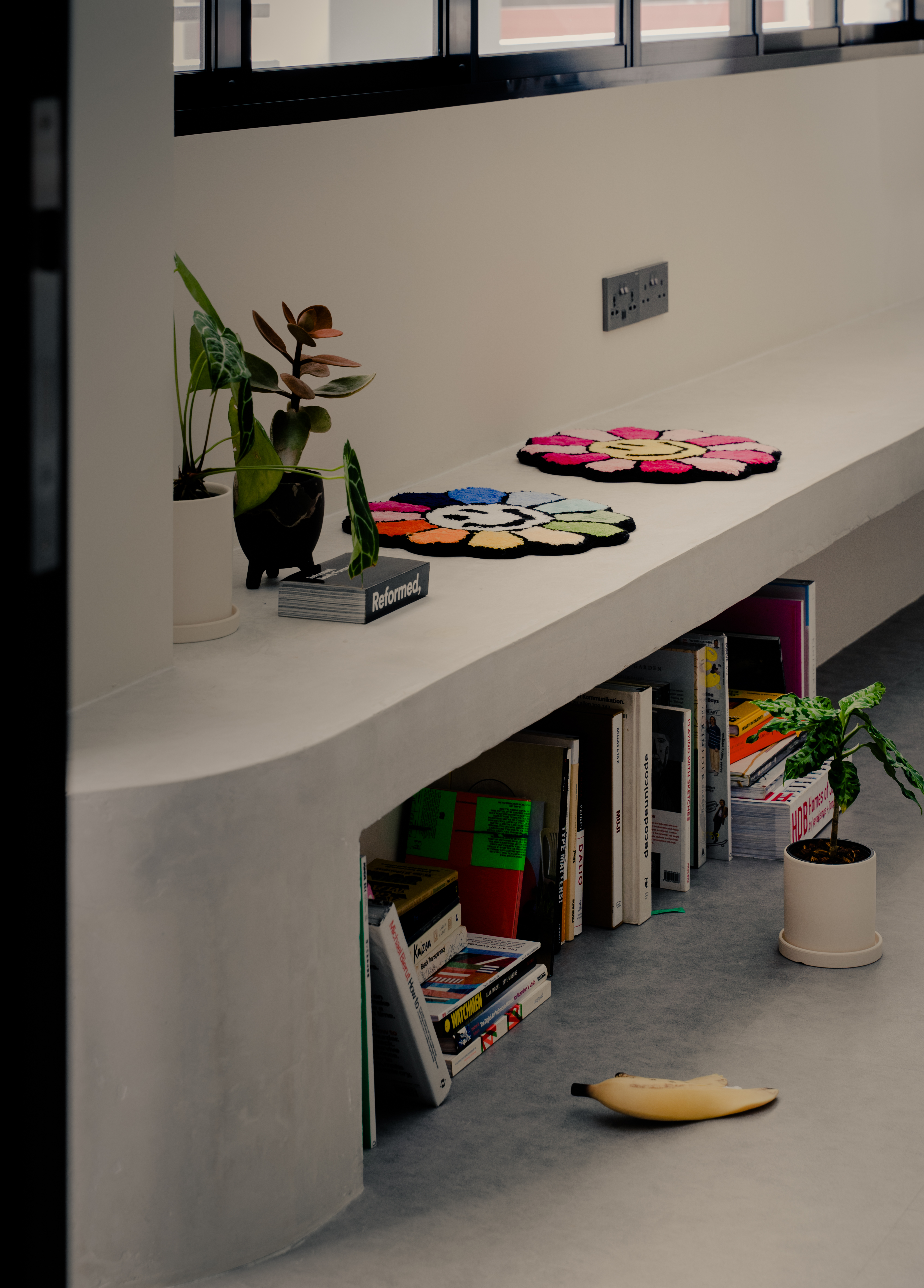 Our Living Area: A space for books, games and quirky clocks - modern living room, minimalist decor, white bench, colorful