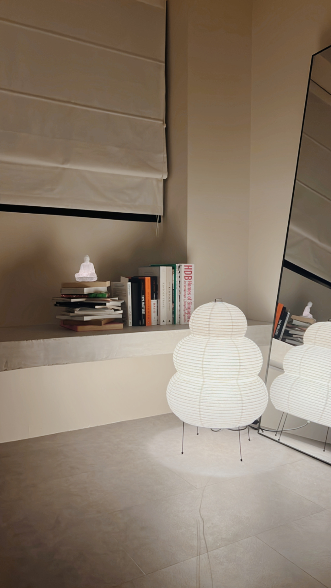 Our Living Area: A space for books, games and quirky clocks - Modern minimalist interior, beige walls, stack of books, white