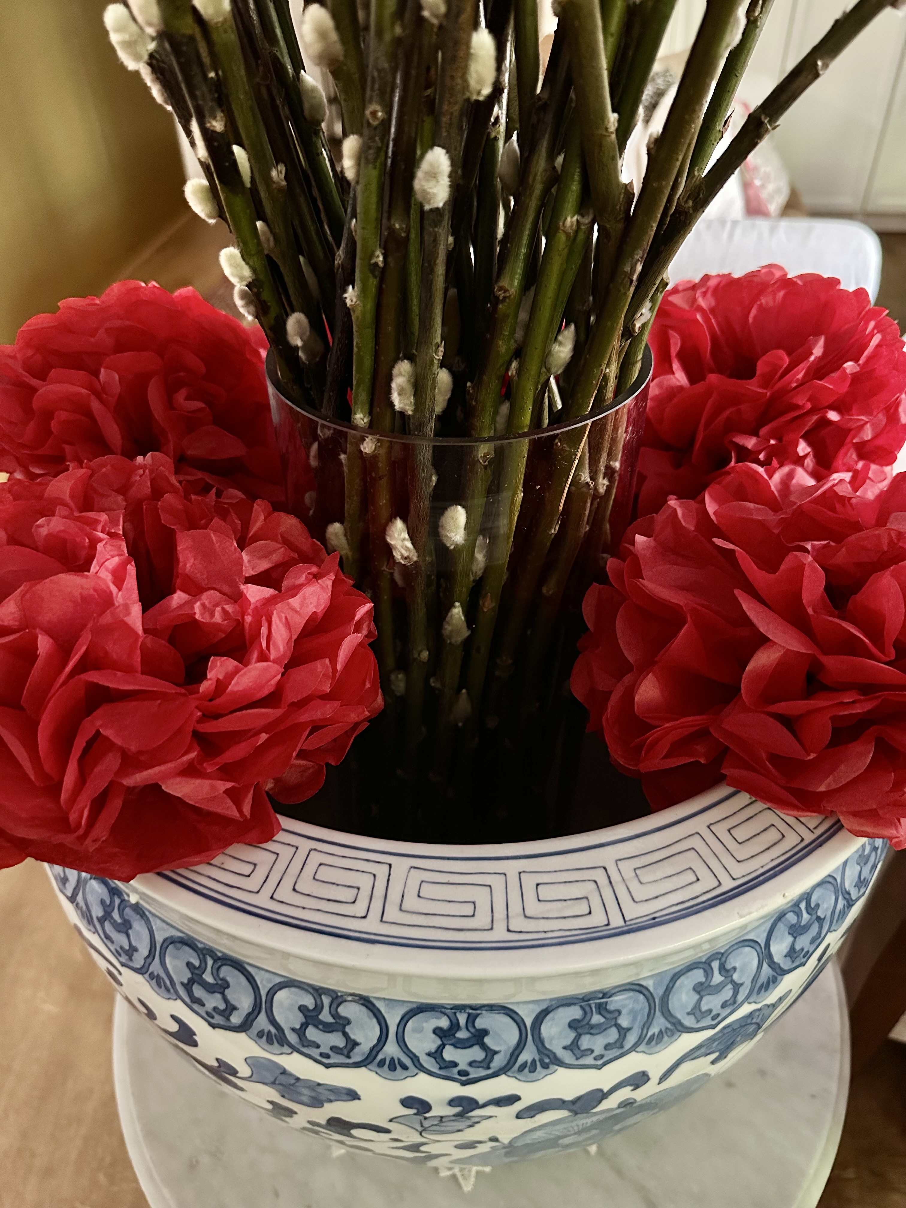 A Festive Home Ready to Welcome the Year of Dragon - vibrant red flowers, decorative arrangement, lush green stems, white