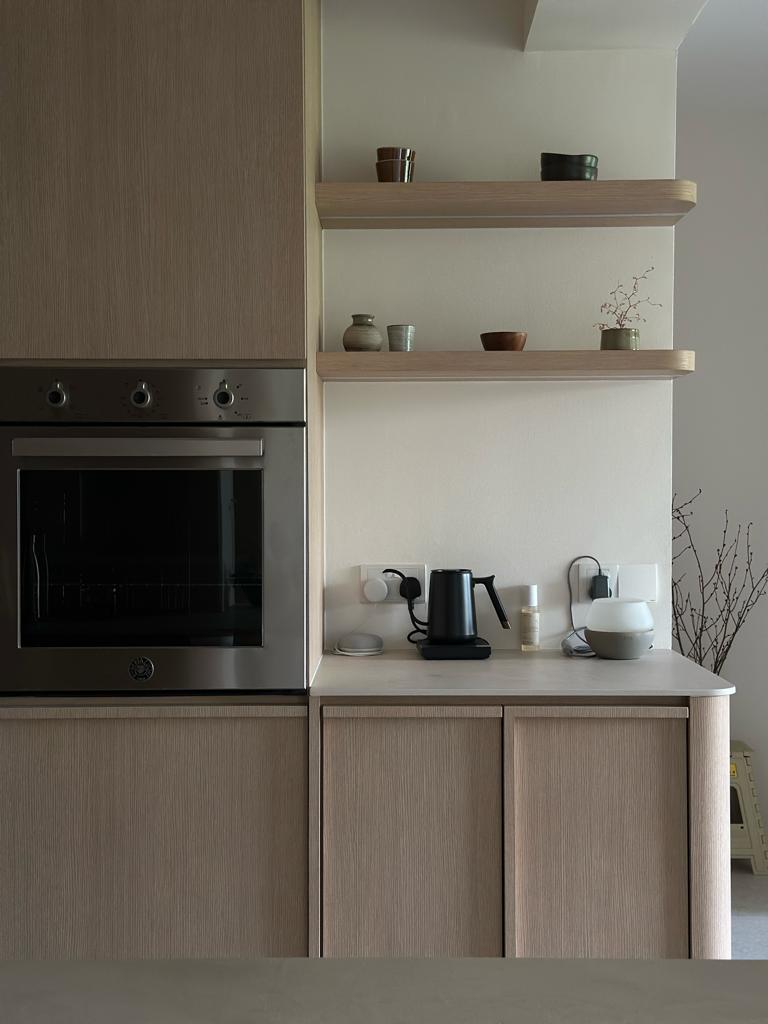 Our kitchen, the heart of our home  - Modern kitchen with built-in oven, light wood cabinets, sleek design, minimalist decor