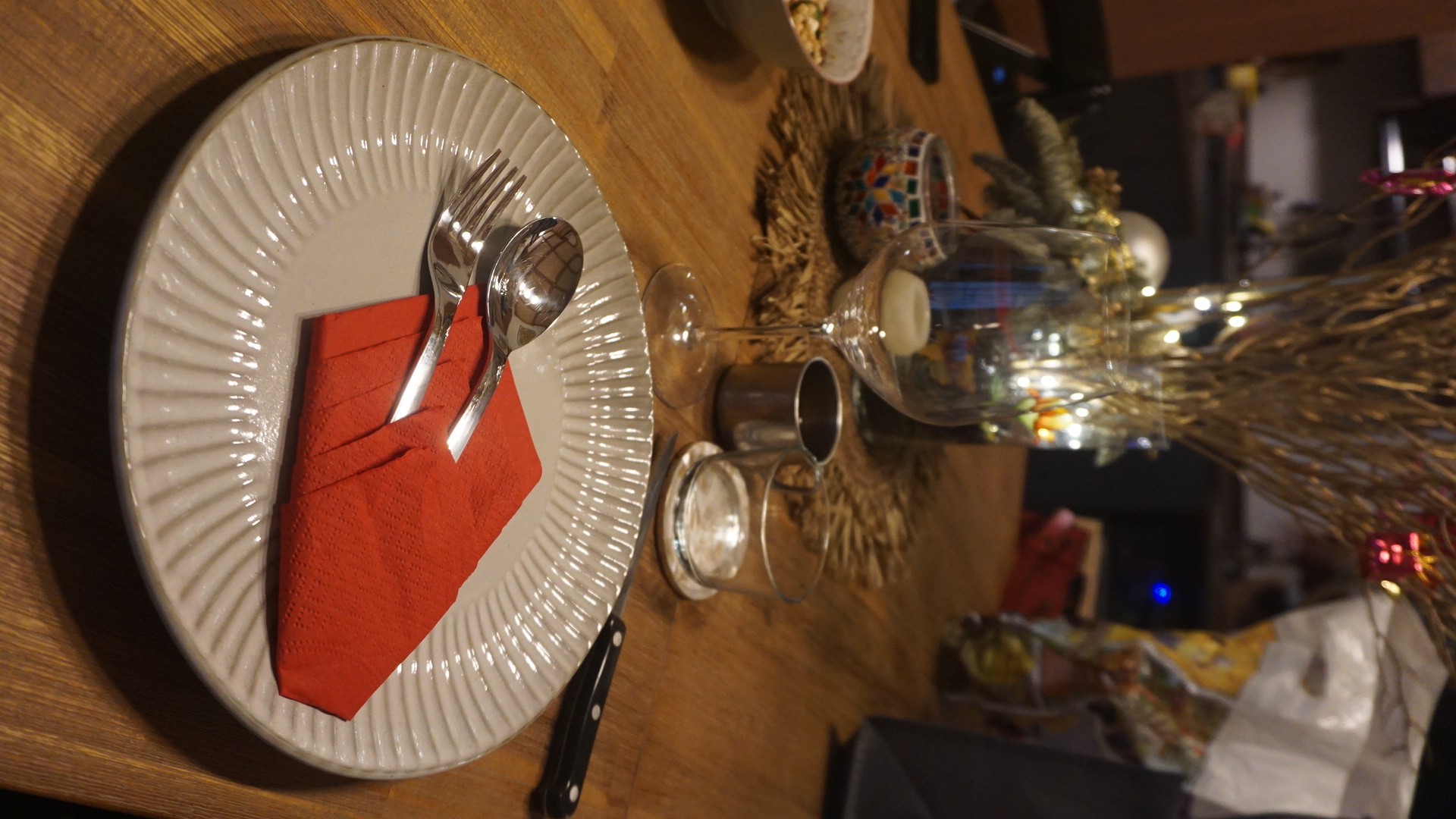 Dining Area Tour: Perfect for Hosting! - White plate with red napkin, silverware, glass, candle holder, decorative items