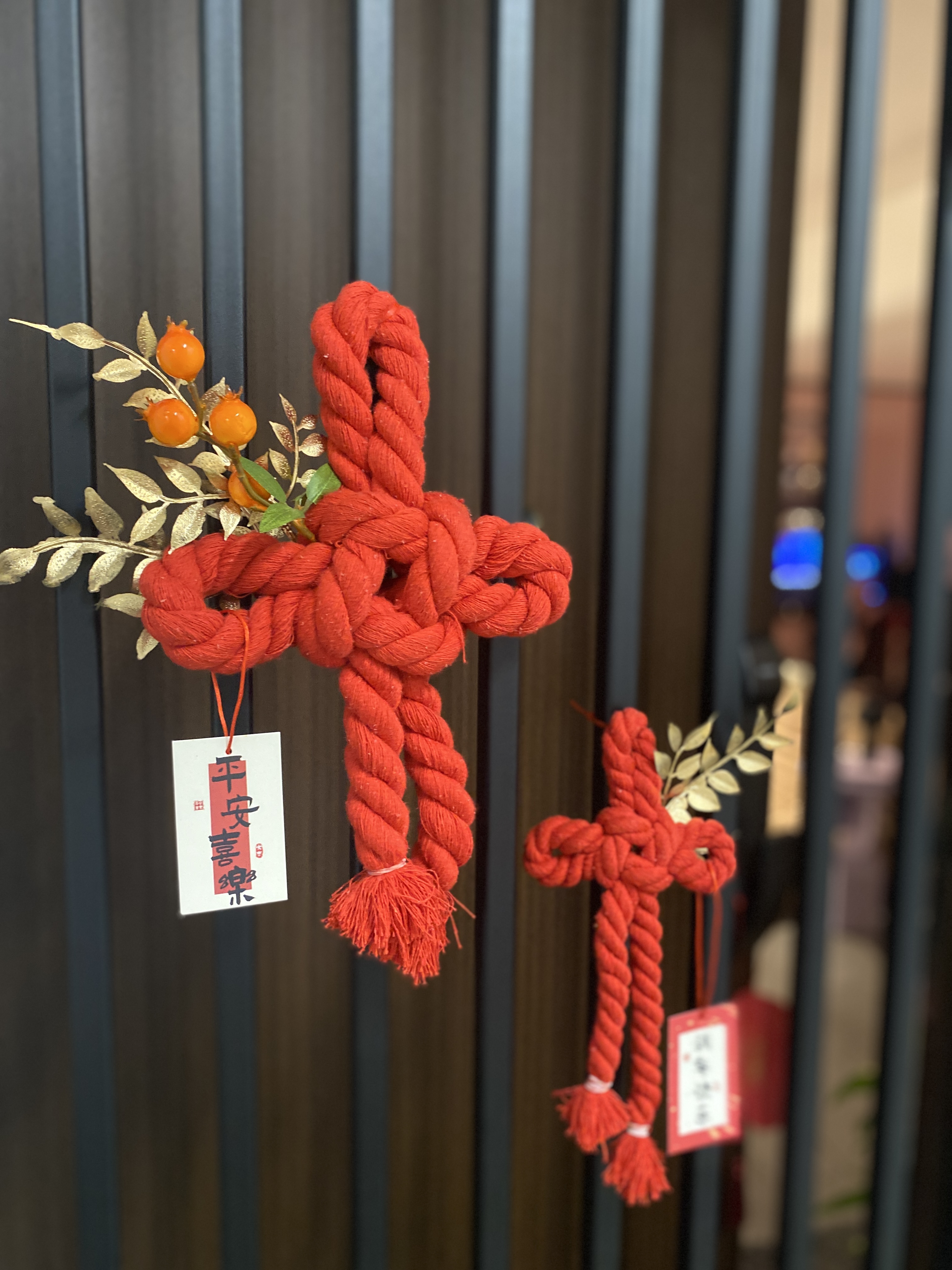 Trying not to lose the CNY essence with our contemporary CNY deco - Red rope cross, festive decoration, orange berries
