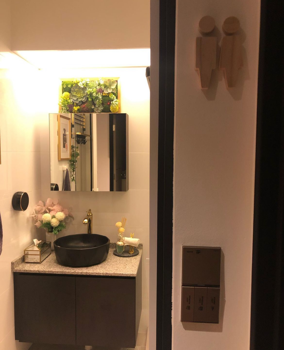 Washroom: Black and gold theme with plants for a relaxing ambiance  - Modern bathroom vanity, sleek black sink, minimalist