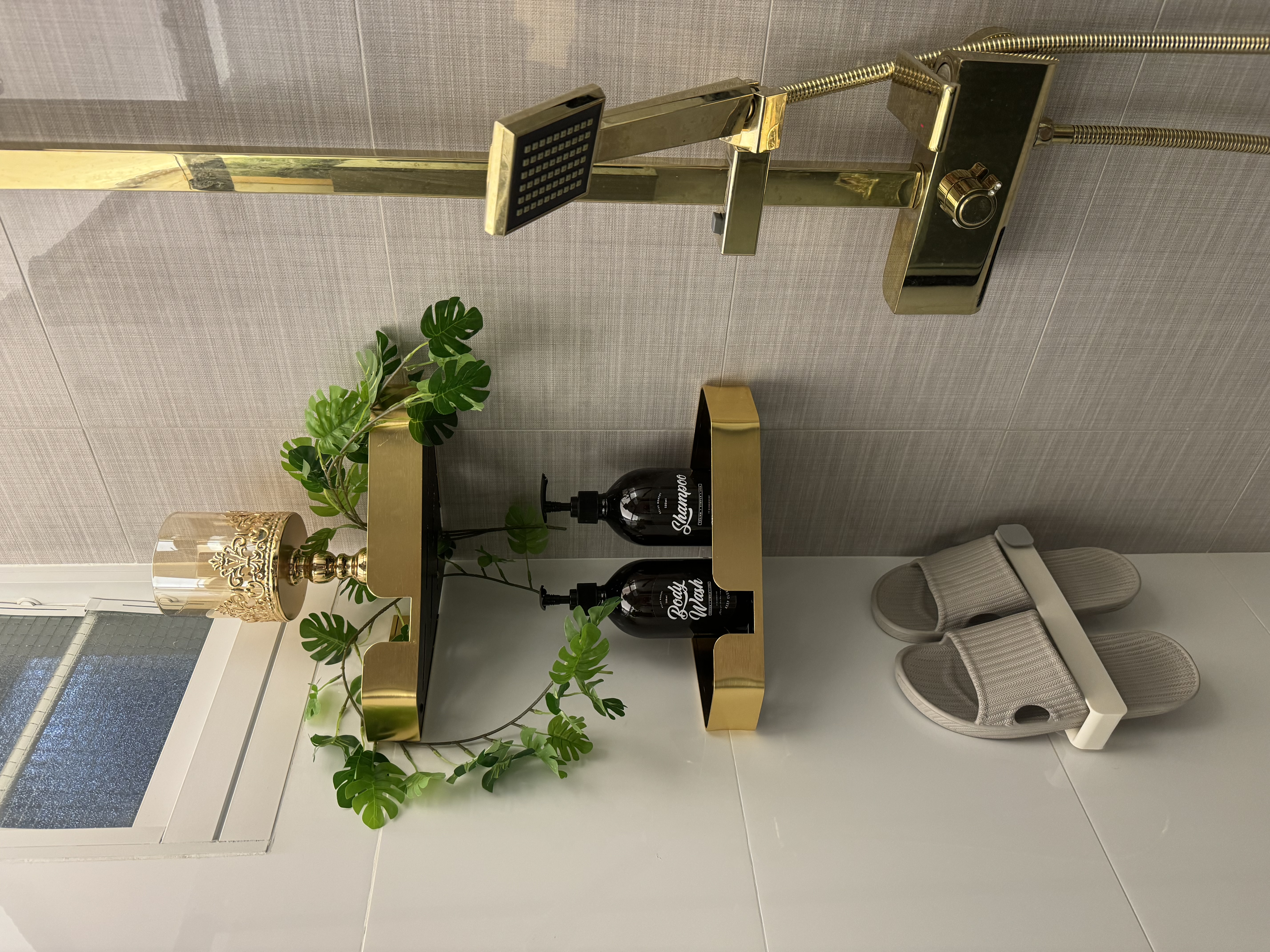 Washroom: Black and gold theme with plants for a relaxing ambiance  - Golden bathroom fixtures, modern design, sleek