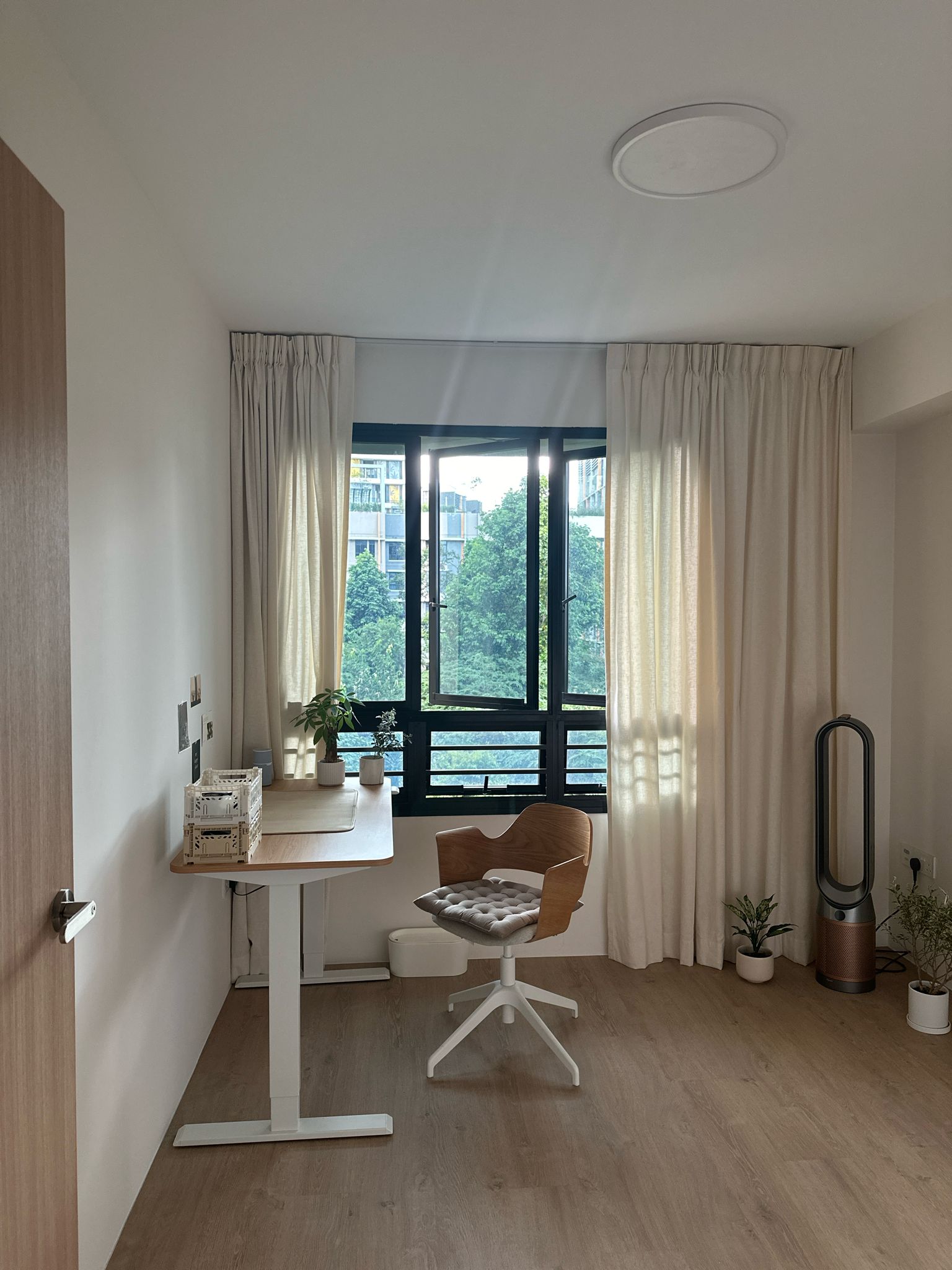 Minimalist Home Office  - Wooden desk, beige chair, modern decor, large window, beige curtains, indoor plants, minimalist