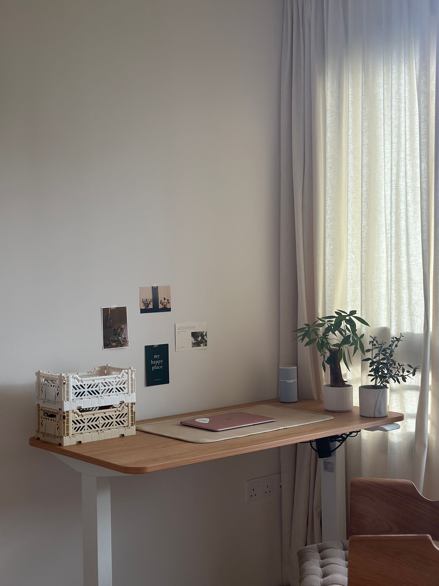 Minimalist Home Office  - Wooden desk, minimalist design, natural light, potted plants, white crate, beige curtains, wall