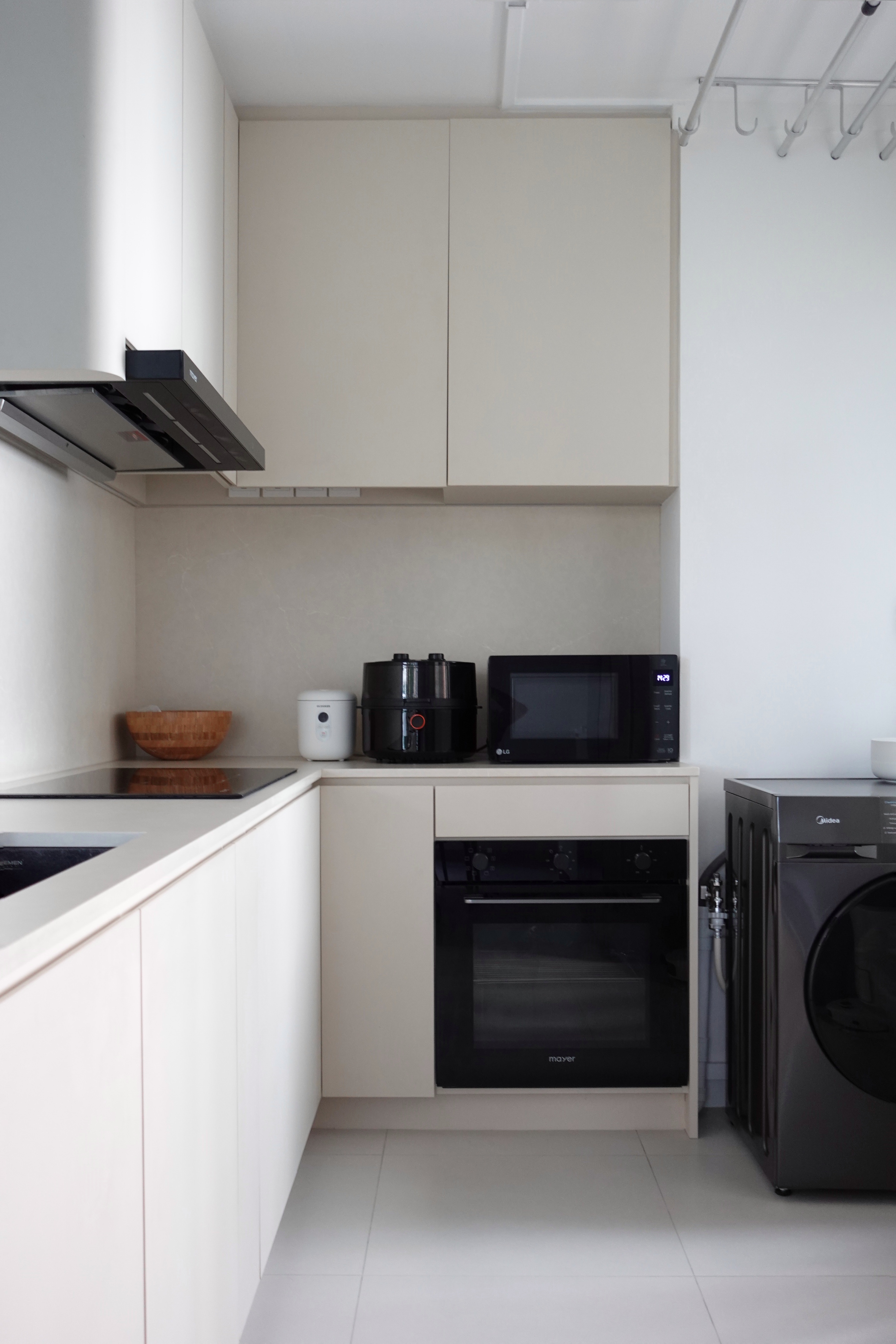 How we hid everything for a minimal kitchen - Modern kitchen with sleek appliances, minimalist design, white cabinets