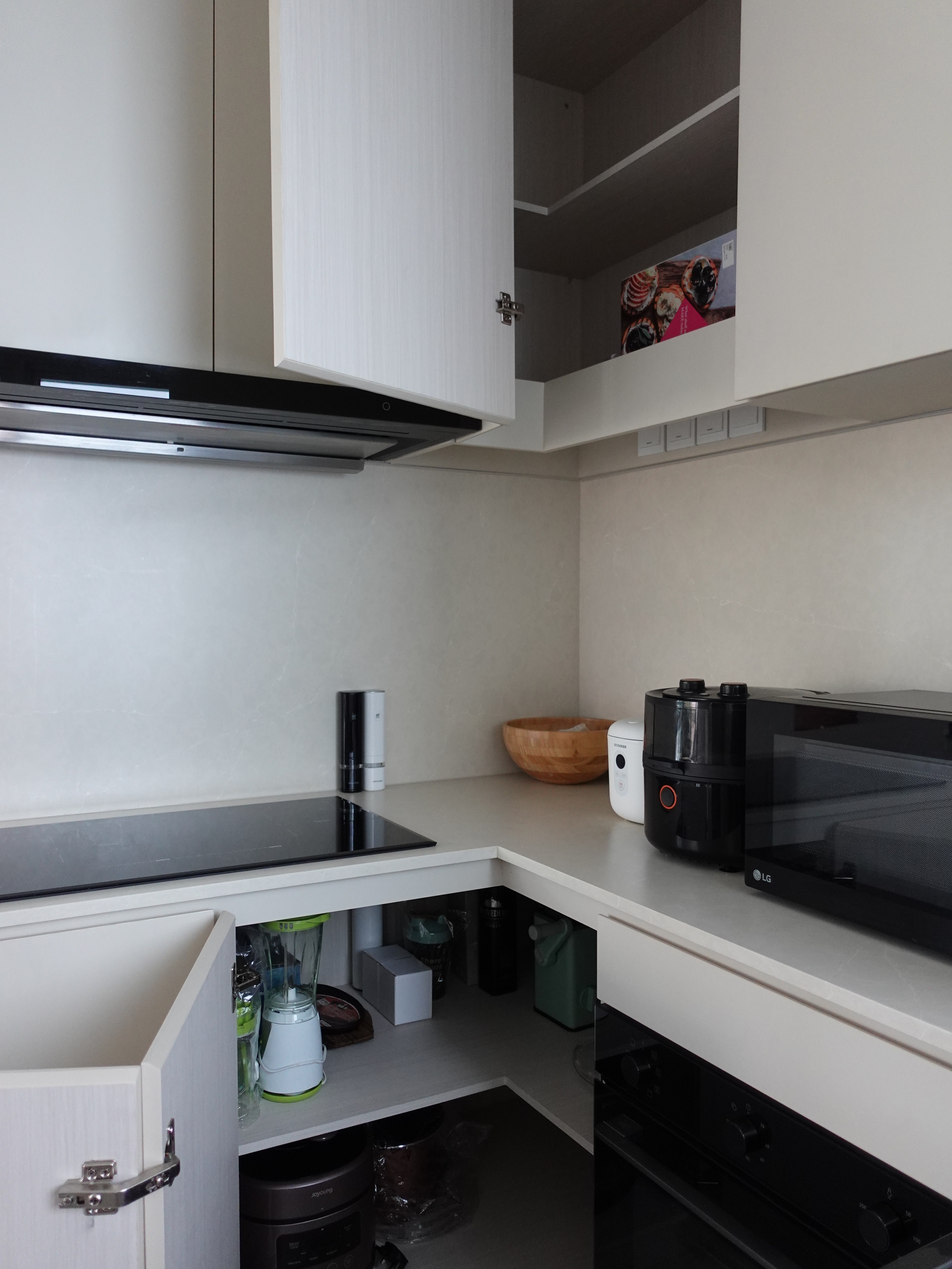 How we hid everything for a minimal kitchen - modern kitchen, compact space, open shelves, white cabinets, black range hood