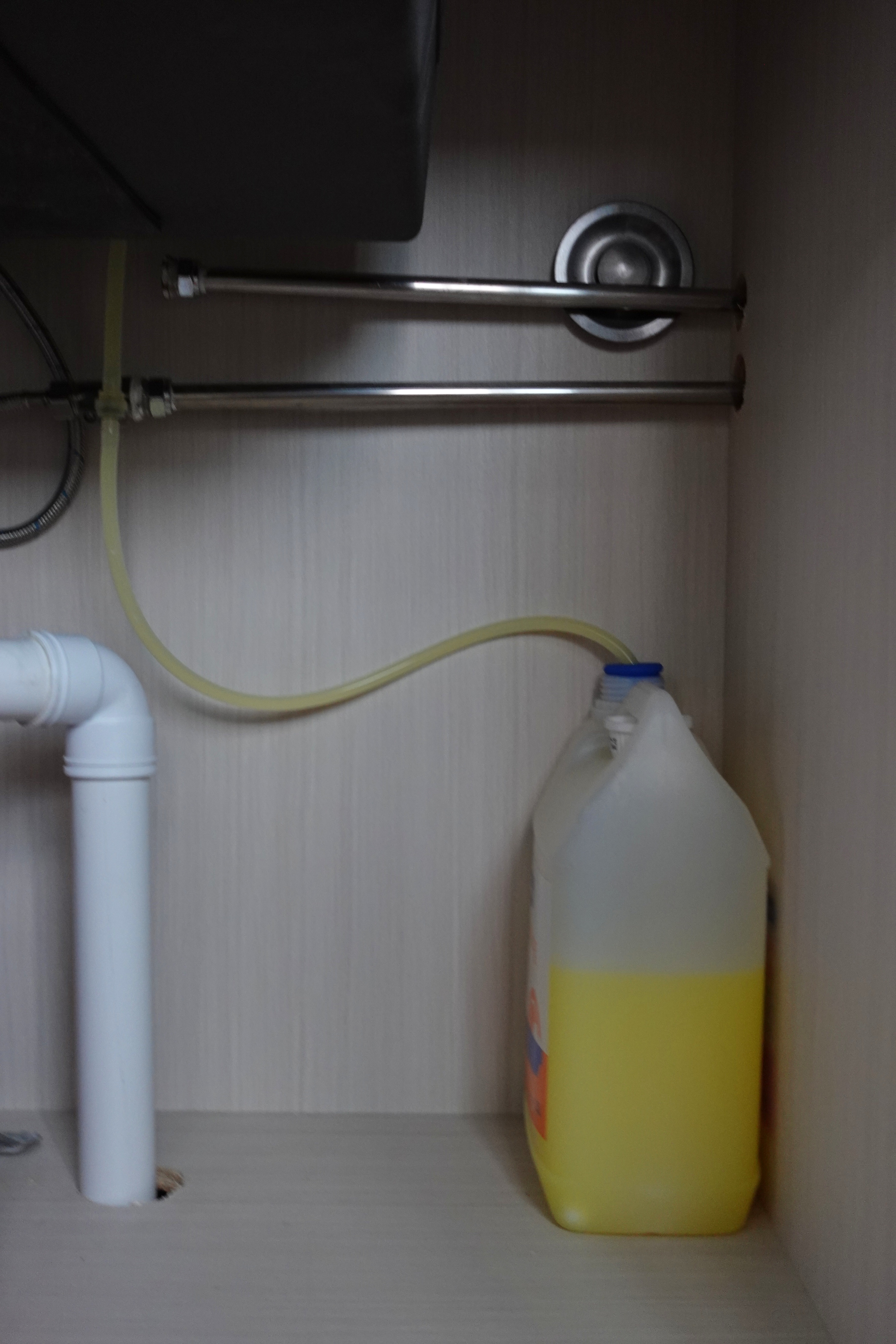 How we hid everything for a minimal kitchen - Undergoing maintenance, plumbing setup, wall-mounted fixtures, yellow flexible