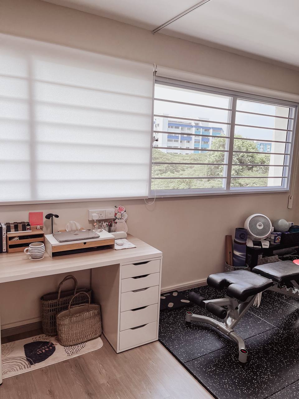 The half-half room - Workspace with laptop, desk organizer, and stationery, natural light streaming through window