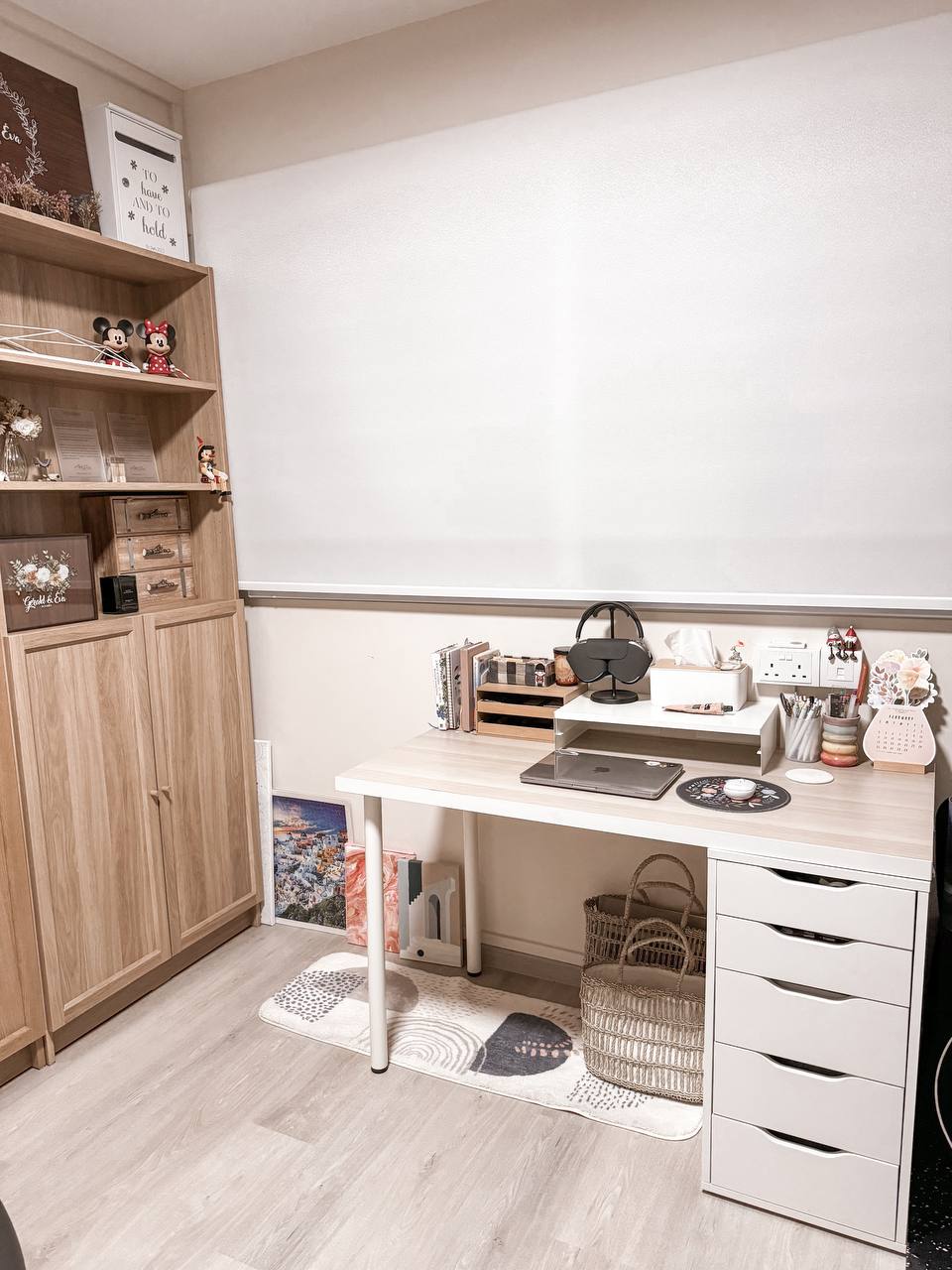 The half-half room - Wooden bookshelf, decorative items, framed quotes, small figurines, notebooks, stationery, laptop, desk