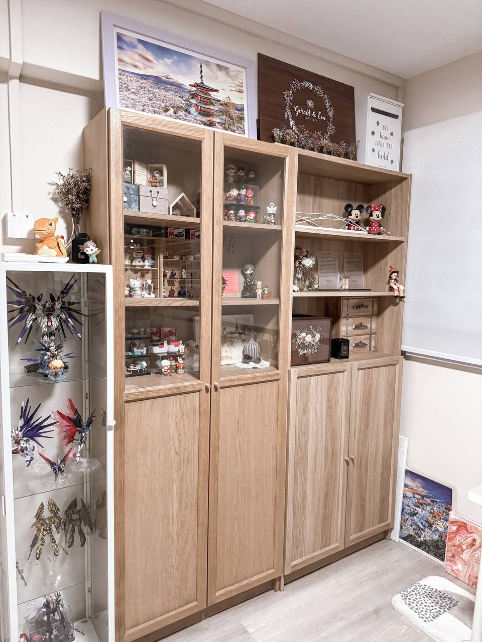 The half-half room - Wooden cabinet, anime figurines, decorative items, photo frame, landscape painting, whiteboard