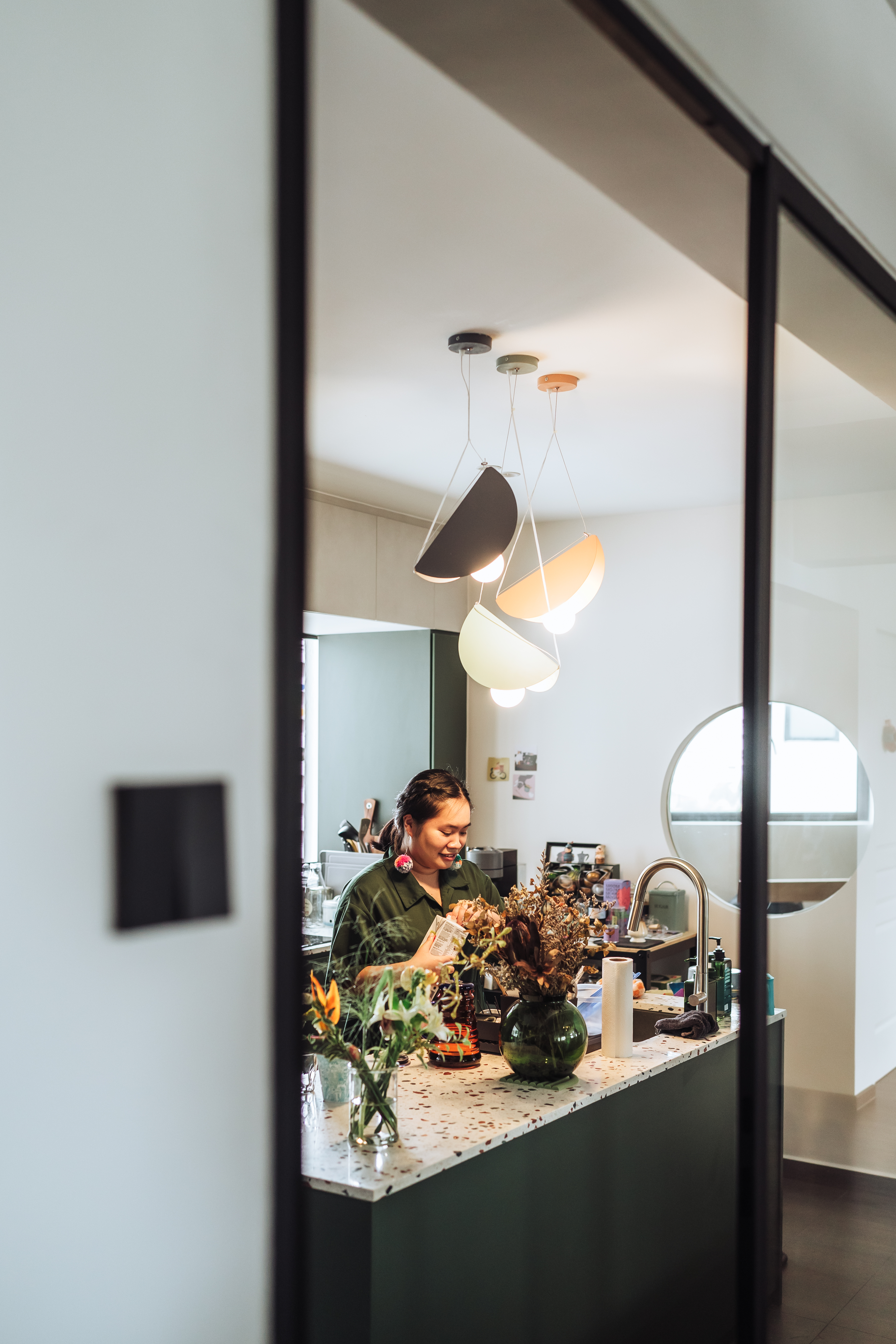 Spacious eclectic kitchen with large countertop!  - Modern kitchen interior, woman working, green apron, vase with flowers
