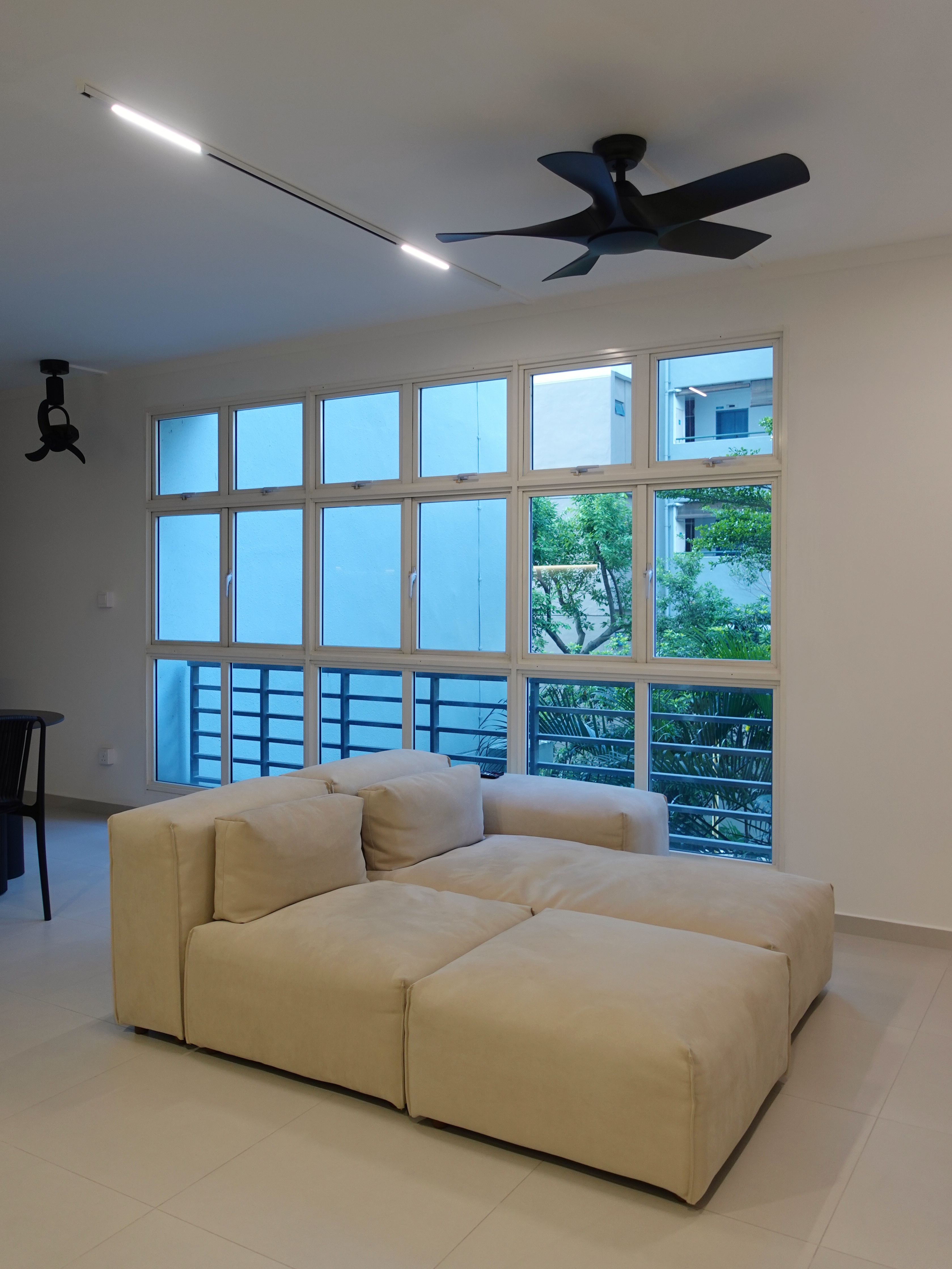 A minimal living room with a full out DIY TV console - Large beige sectional sofa, modern minimalist design, spacious room