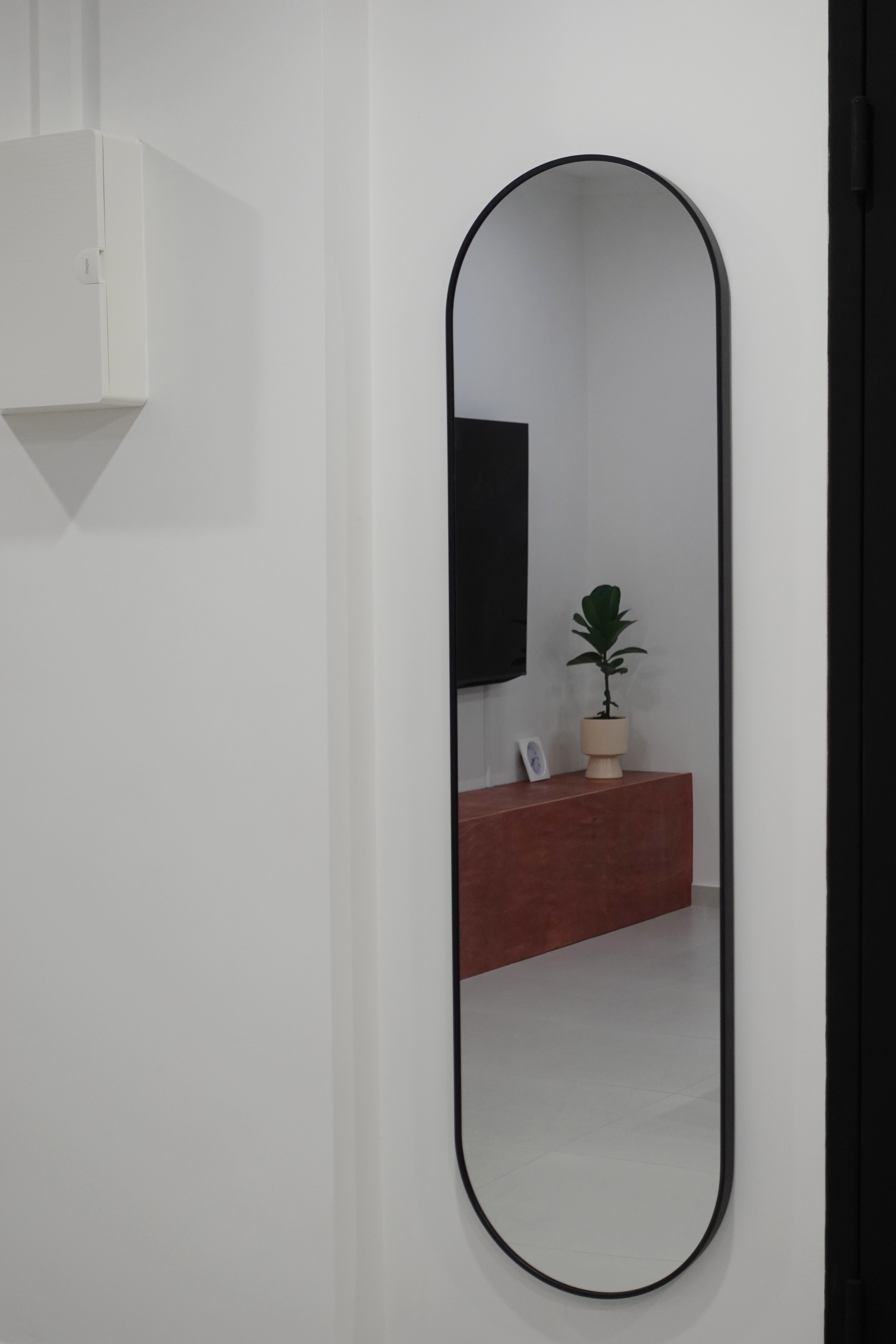 A minimal living room with a full out DIY TV console - White minimalist room, modern decor, black arched mirror, white wall