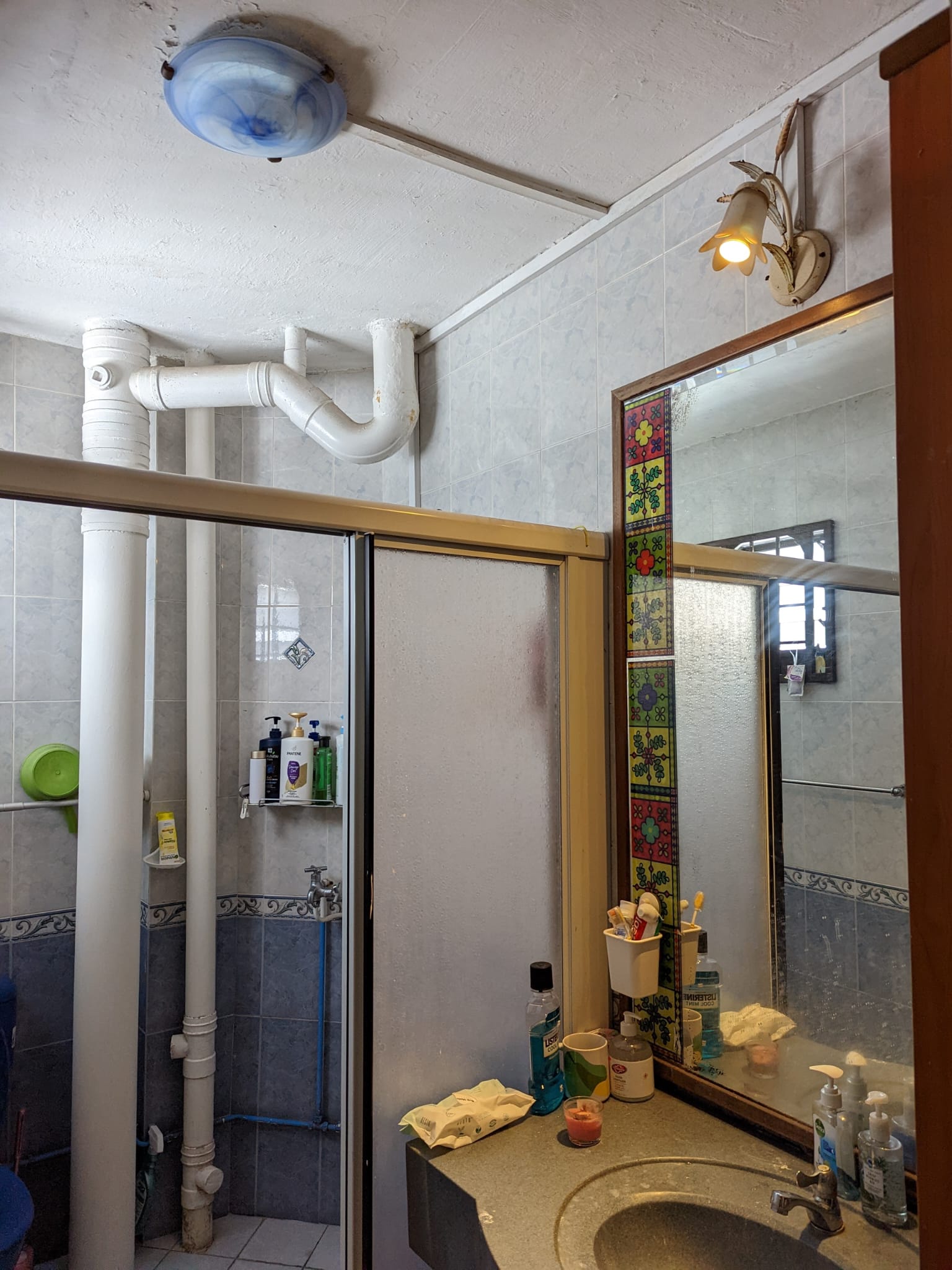 Wired glass - privacy with a fun touch for our toilets - White tiled walls, blue and white ceiling light fixture, white