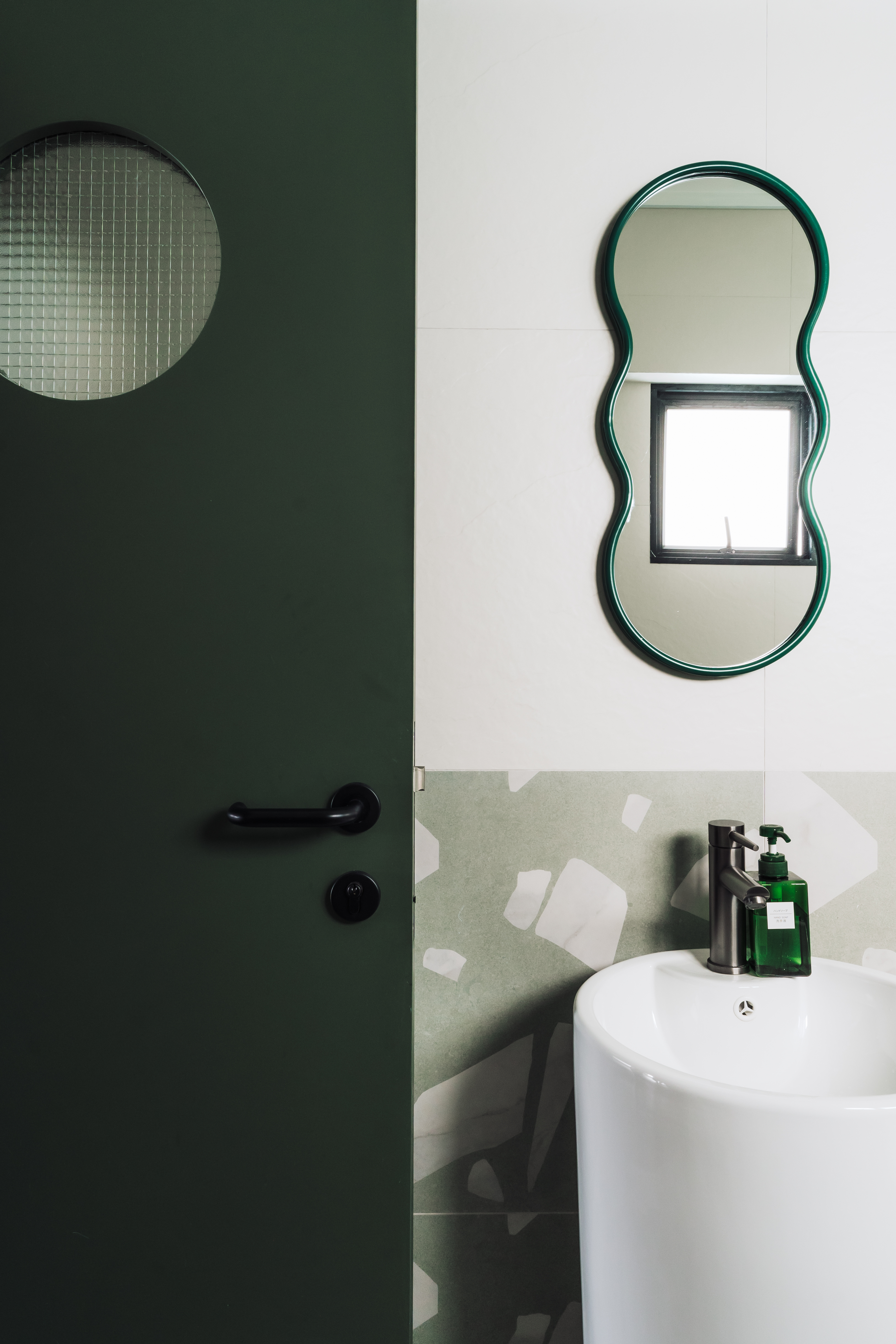 Wired glass - privacy with a fun touch for our toilets - Green door with circular window, green oval mirror, white wall with