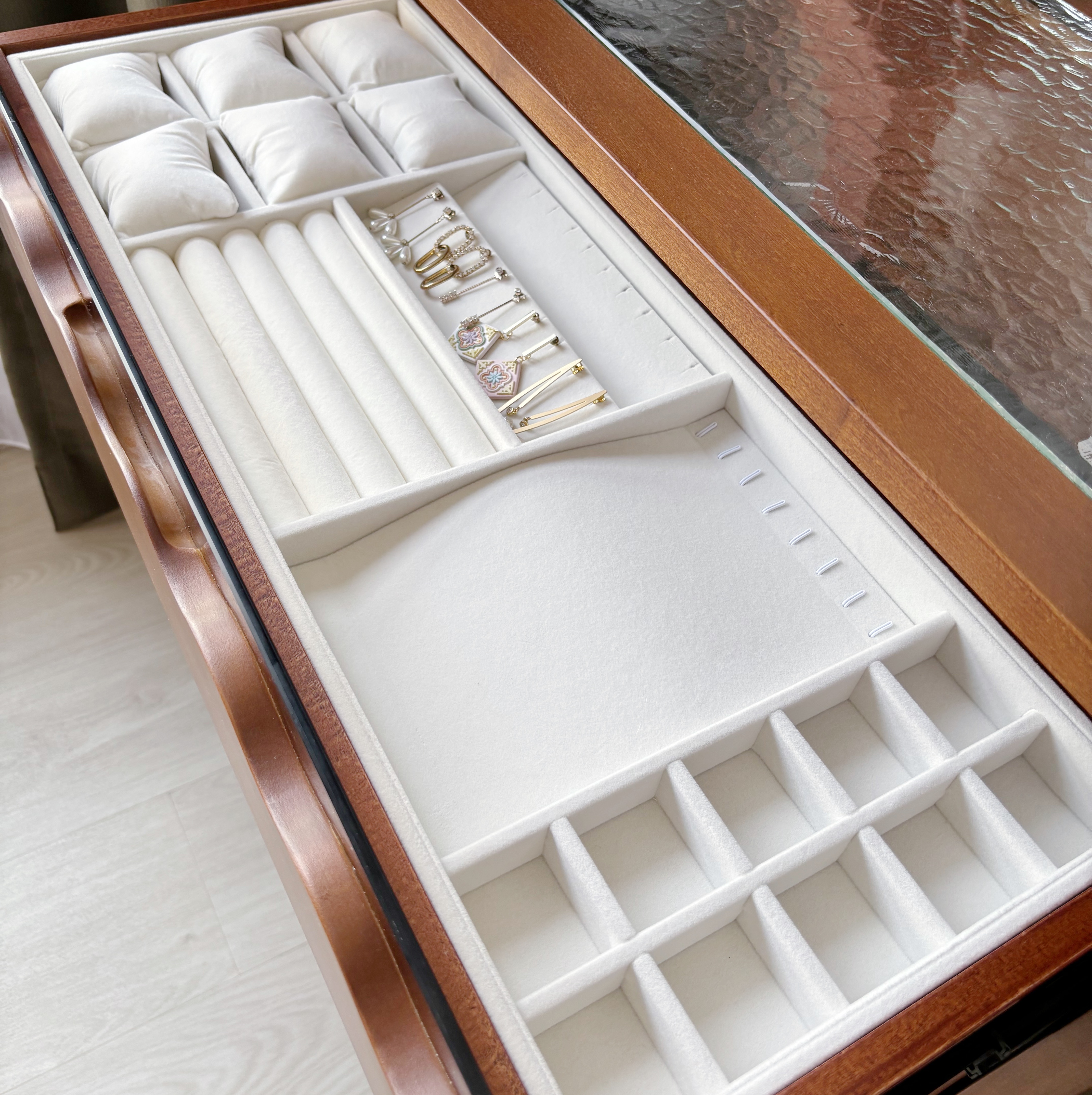 Humble Cozy Guest Bedroom - White jewelry box with cushioned compartments, gold earrings, pearl necklace, elegant jewelry