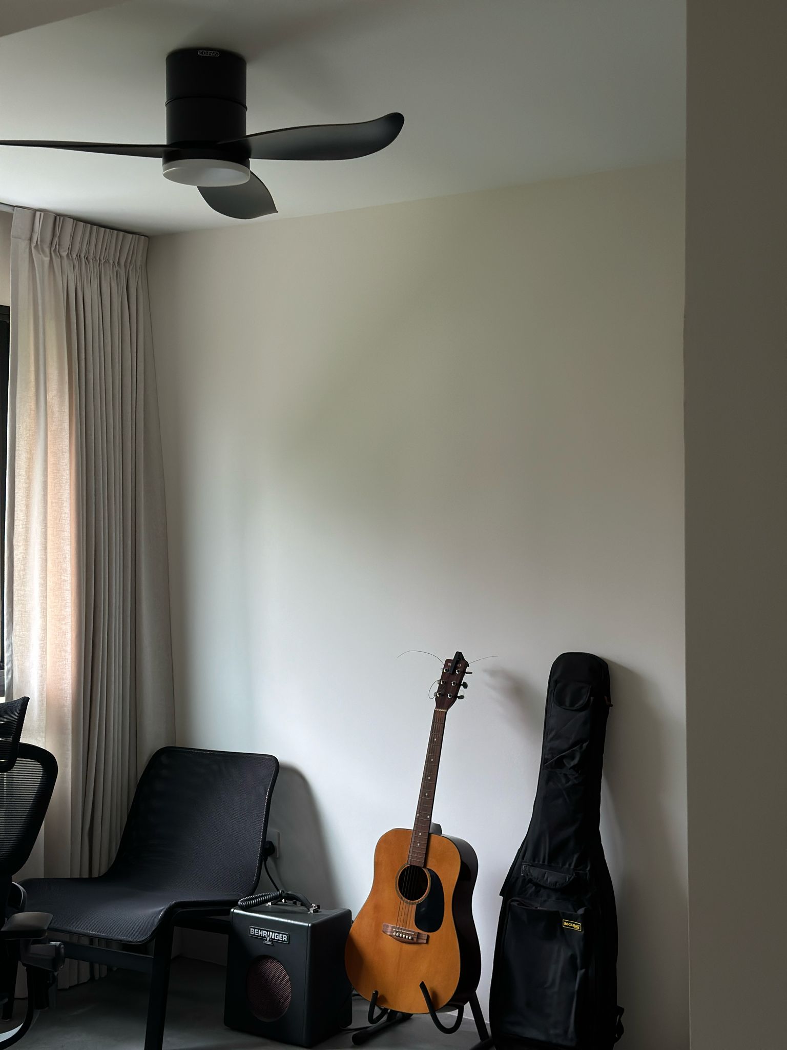 Work Hard Play Hard  - Guitar, acoustic, stand, black guitar case, black chair, ceiling fan, beige curtains, room, minimalist