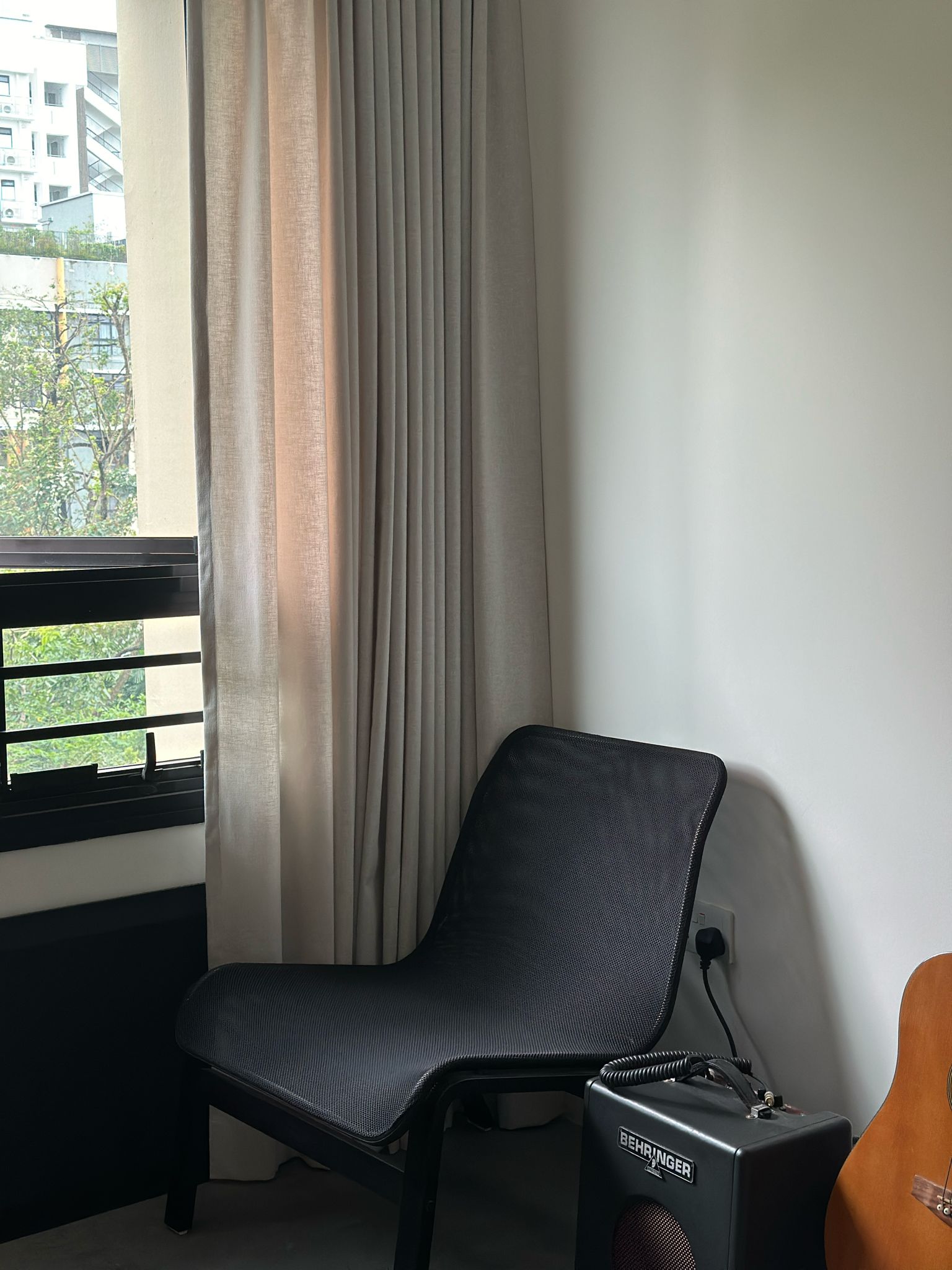 Work Hard Play Hard  - Modern minimalist room, large window, beige curtains, black chair, acoustic speaker, guitar, natural