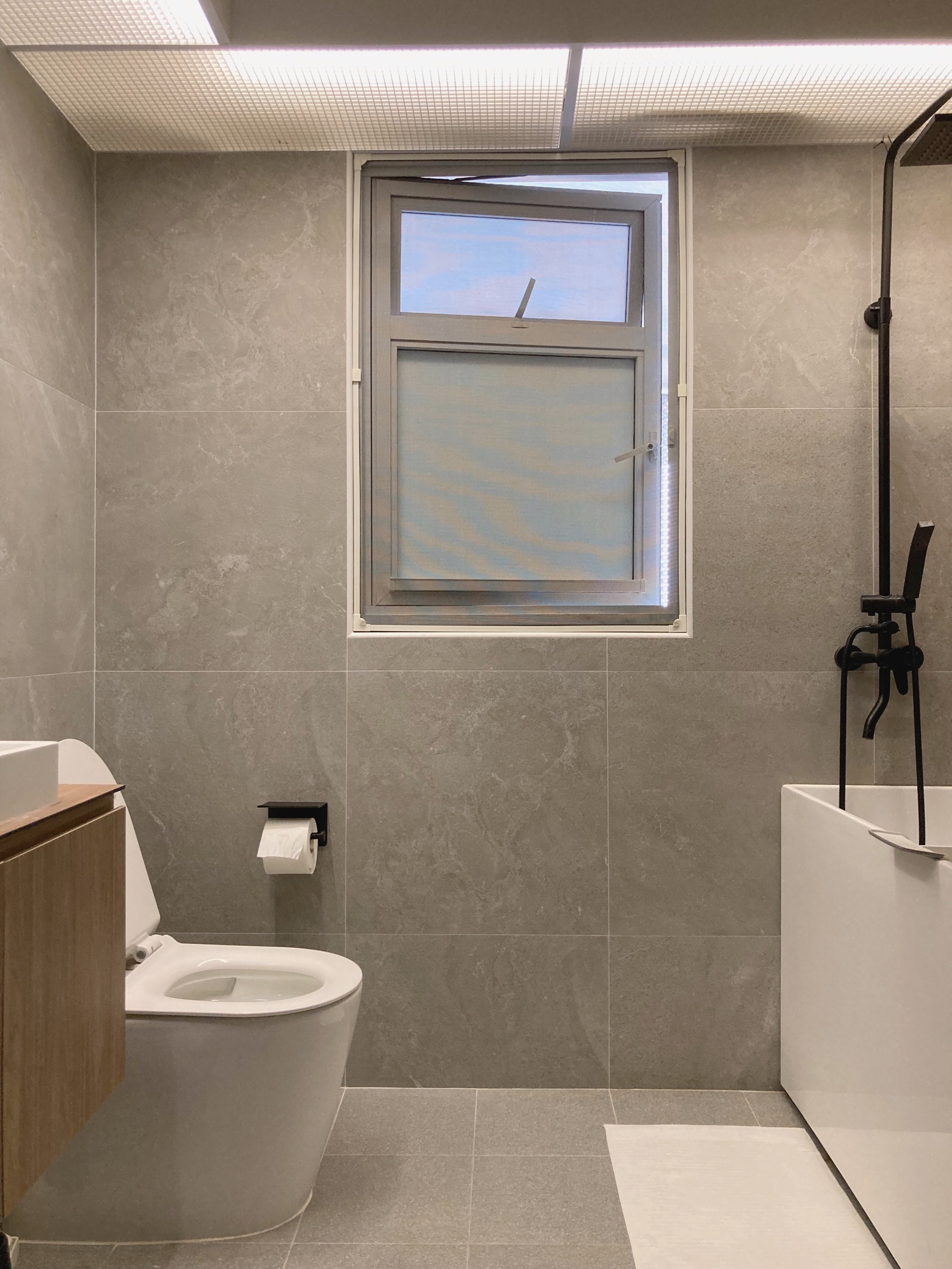 Muji Hotel-inspired toilet with a bathtub - Grey marble tiles, modern design, minimalist bathroom, white toilet, built-in