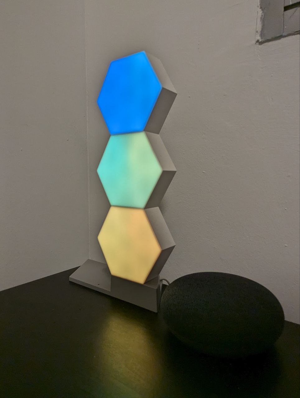 Magic of a home gym - Hexagonal light fixture with blue, green, yellow, and orange panels, modern minimalist design