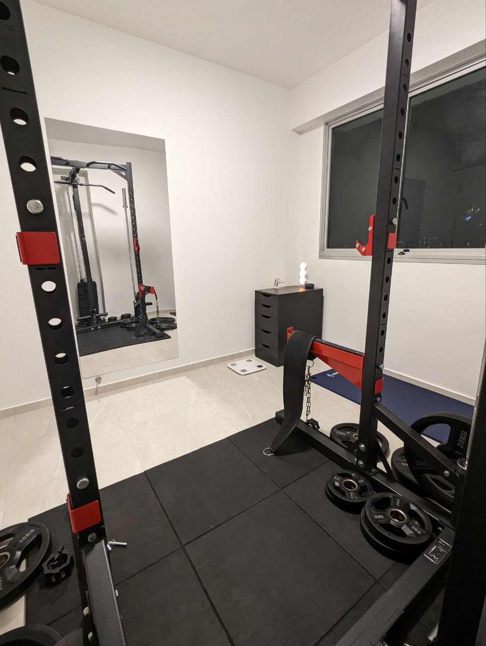 Magic of a home gym - Black and red weightlifting machine, black and red barbell, black and red weight plates, black and red