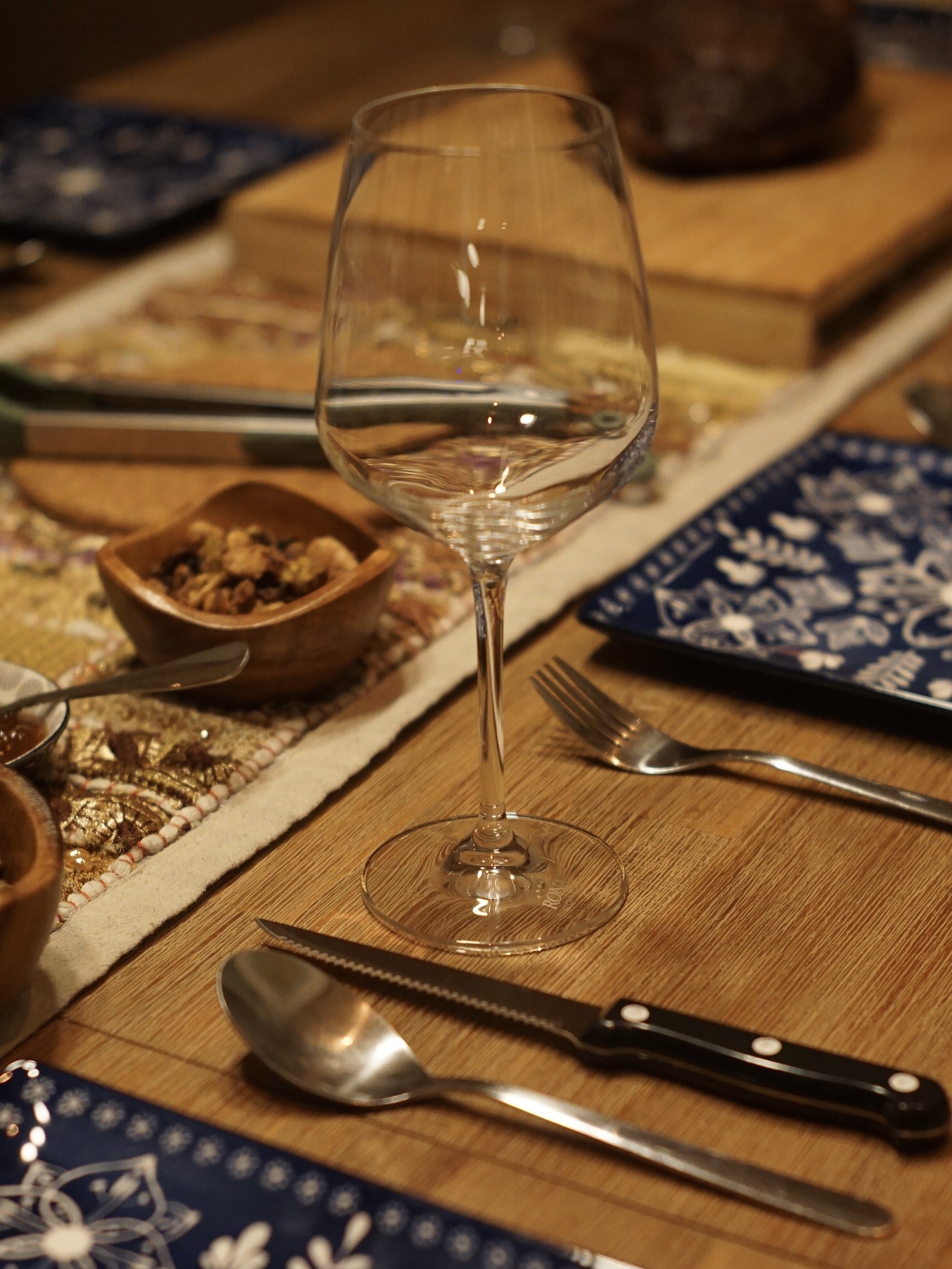 Festive Chinese New Year Vibes at Home - glass wine glass, empty wine glass, table setting, wooden table, blue placemat