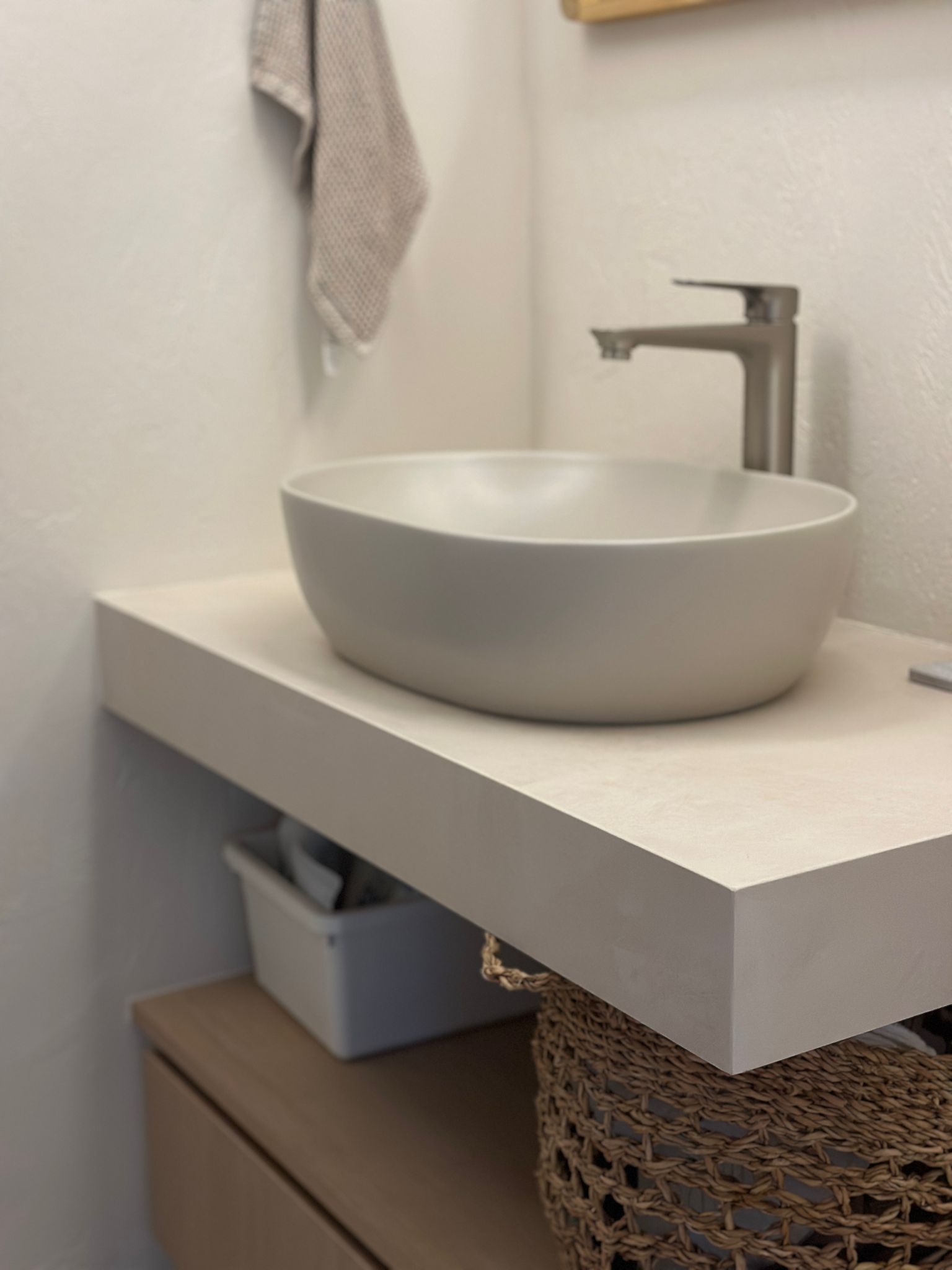 Texture wall in a powder room  - modern bathroom vanity, minimalist sink, floating shelf, neutral color palette, sleek