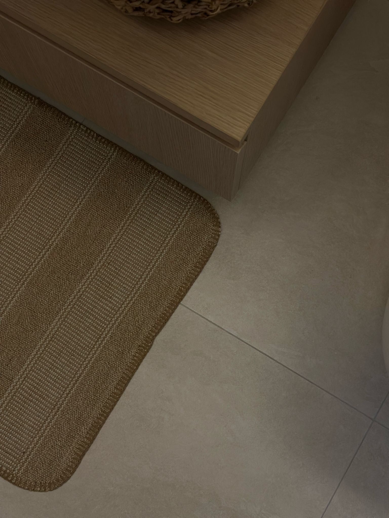 Texture wall in a powder room  - Bathroom countertop, woven rug, textured floor, light brown rug, modern design, wooden