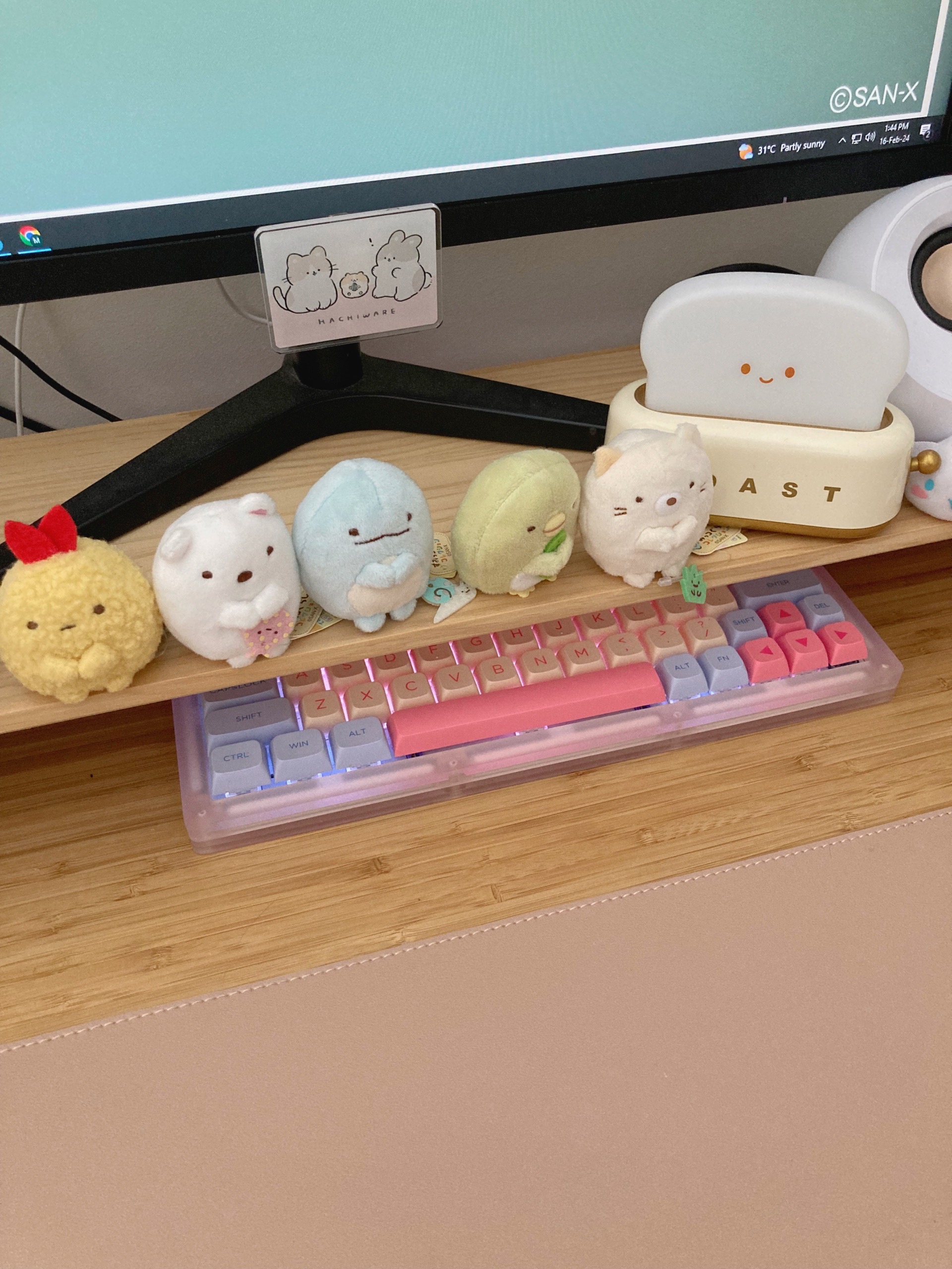 Bright and Open Minimalist Workspace - Cute, pastel-colored plush toys on a desk, Pink, blue, yellow, and white keyboard