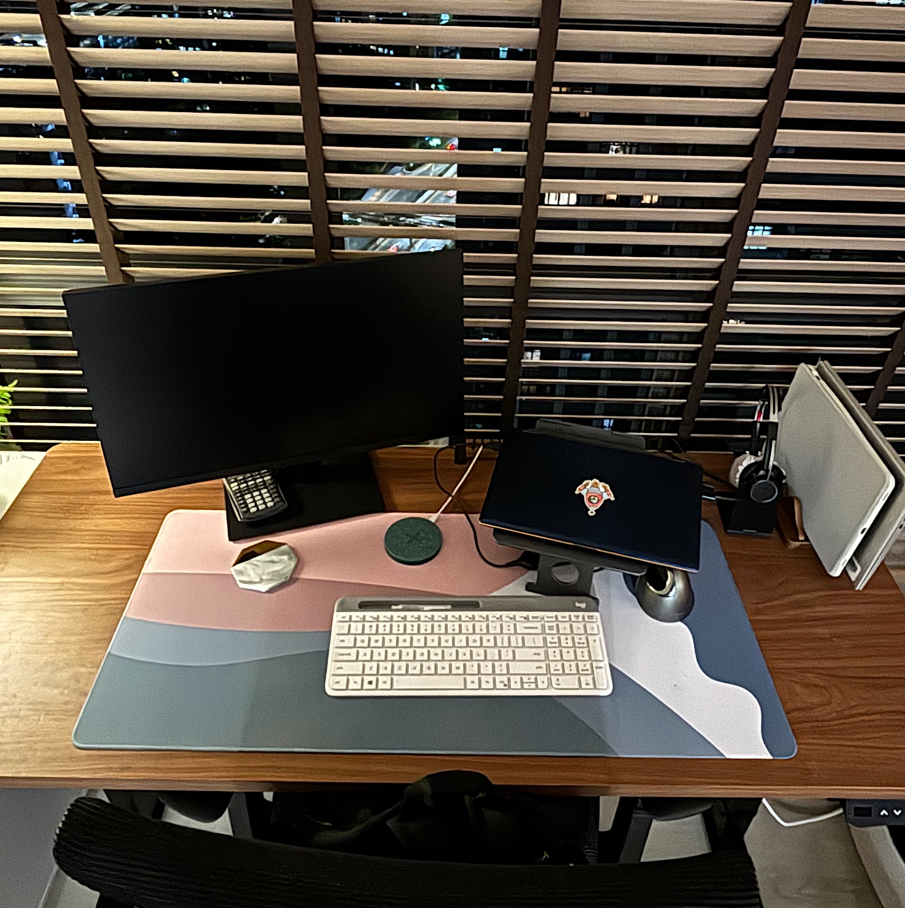 Creating a productive, focused and creative workspace! - Black computer monitors, wooden desk, pink and blue mouse pad, white