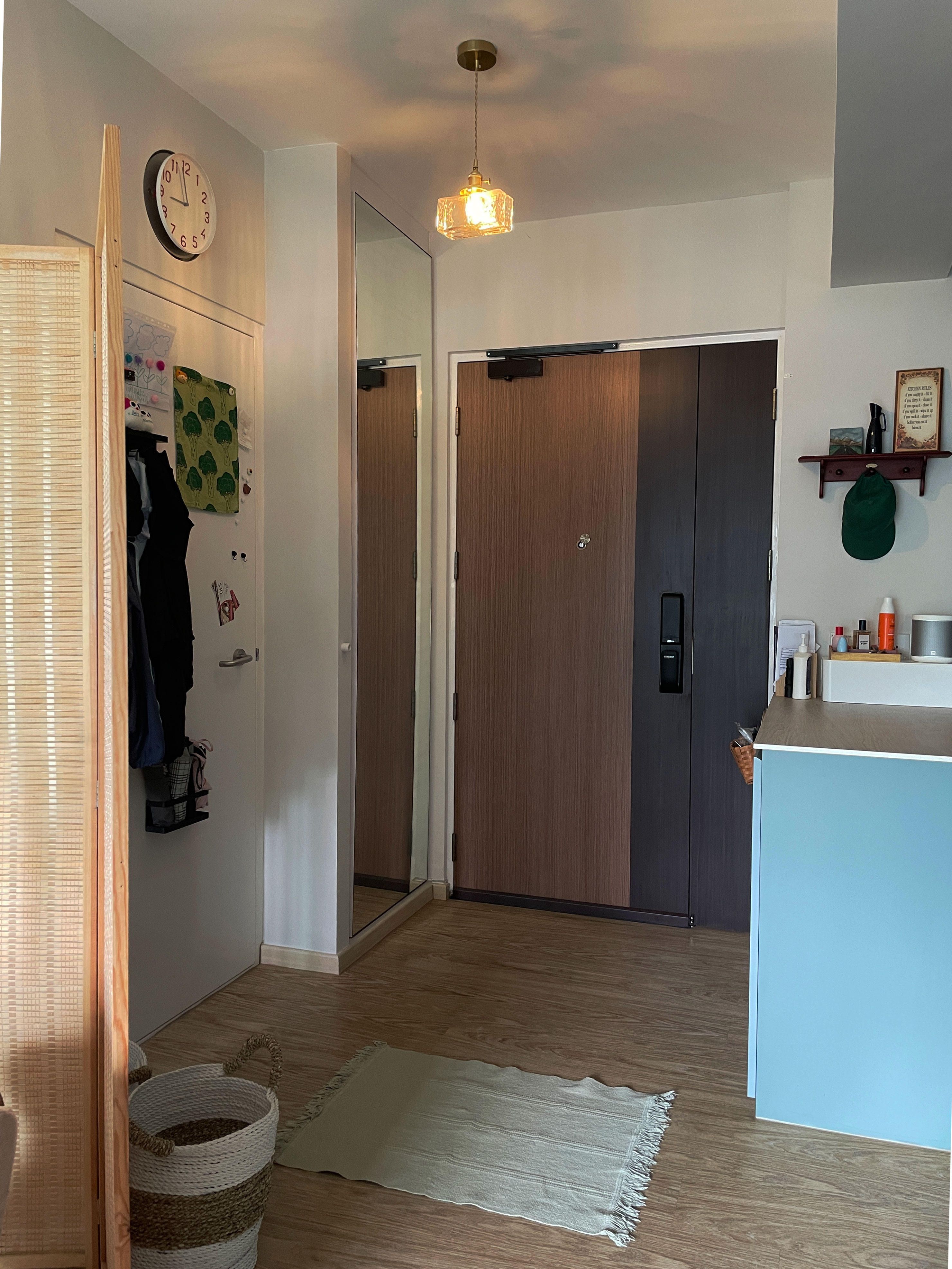 Keep prying eyes 👀 away: Maintaining privacy in your foyer - Wooden floor, woven basket, light green rug, white wall, wooden