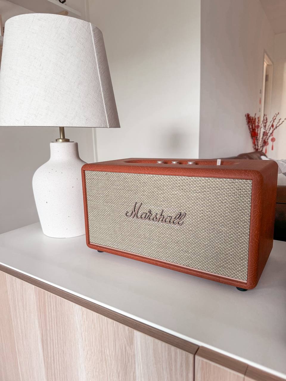 Entryway  - Marshall vintage radio, white lamp with textured shade, wooden base, minimalist decor, modern interior, cozy